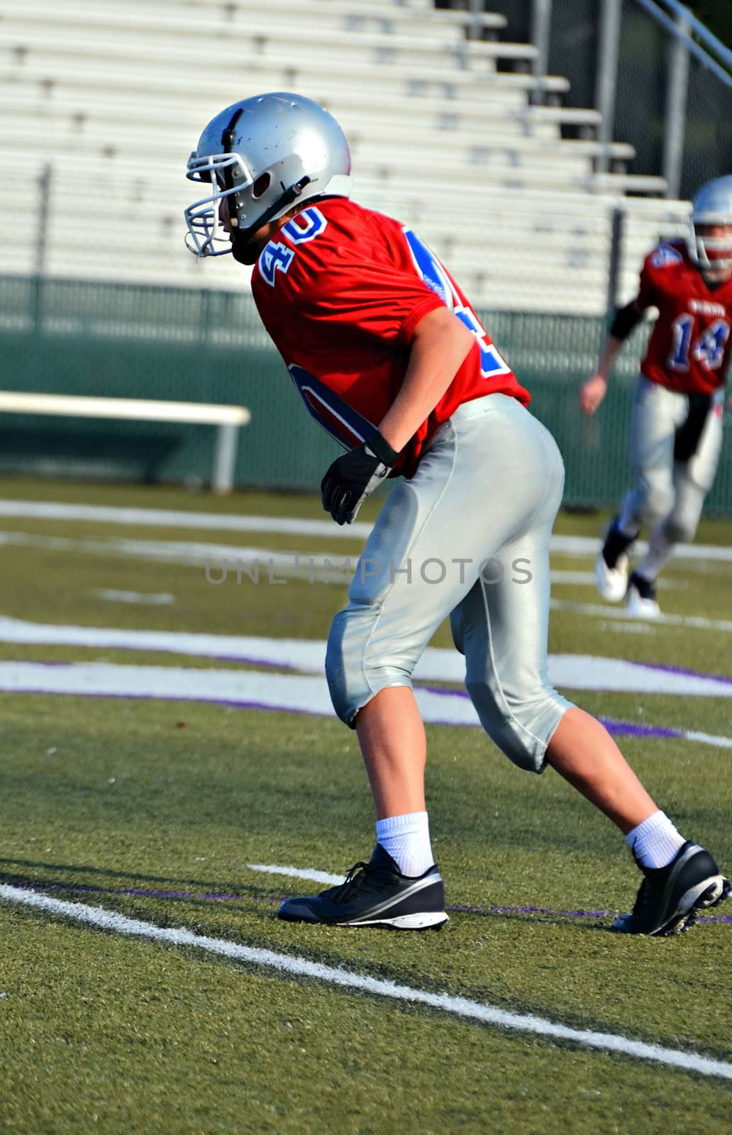 A preteen football player ready for action in a game.