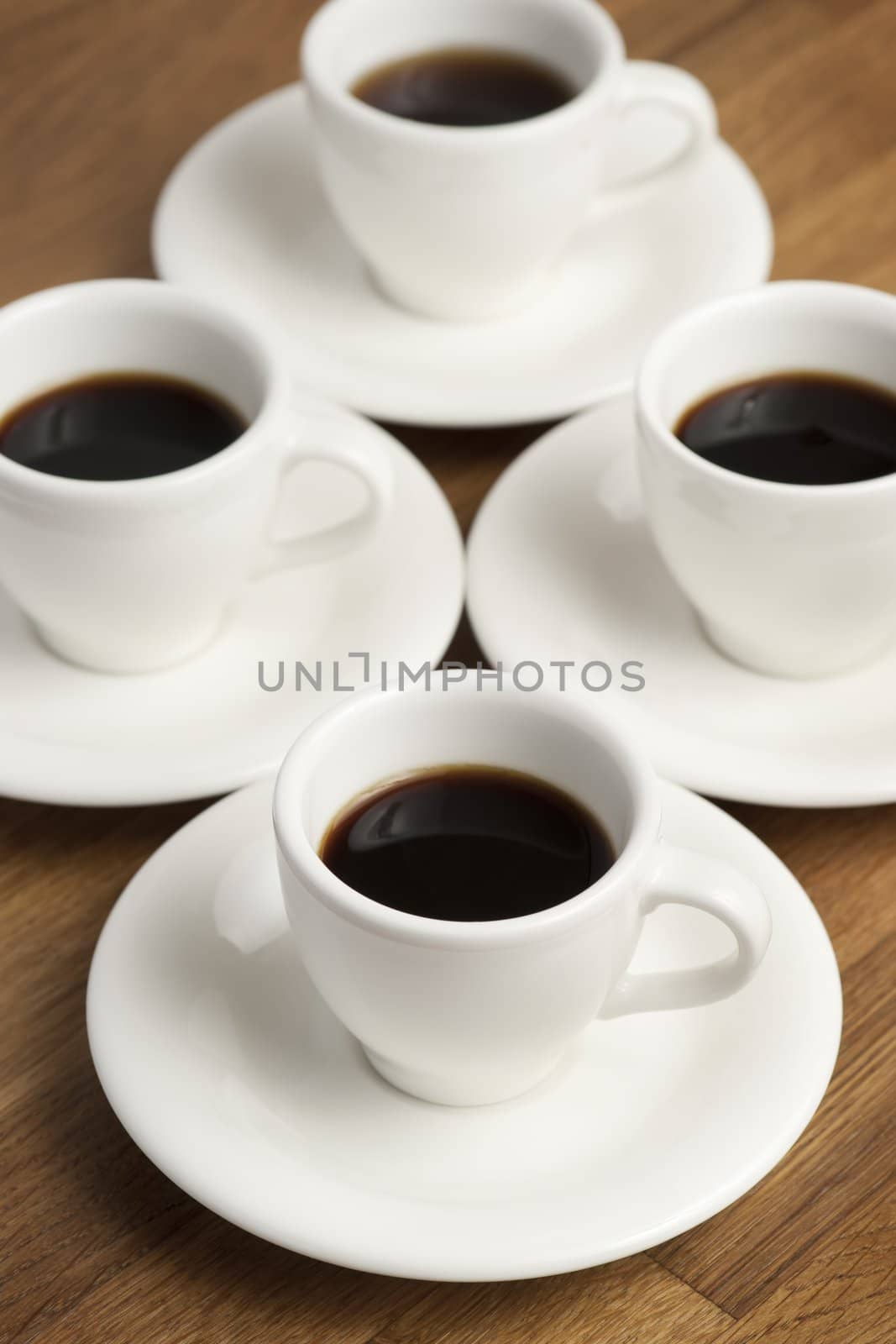 Four white coffee cups on the table.