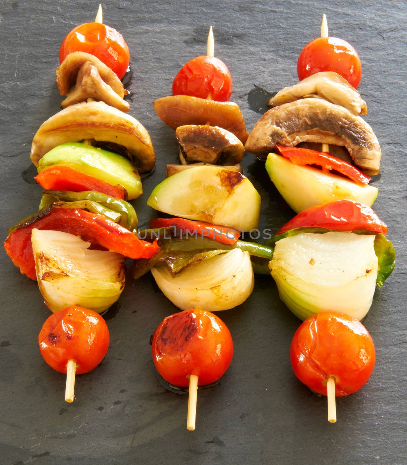 Vegetable brochettes on a black slate tray