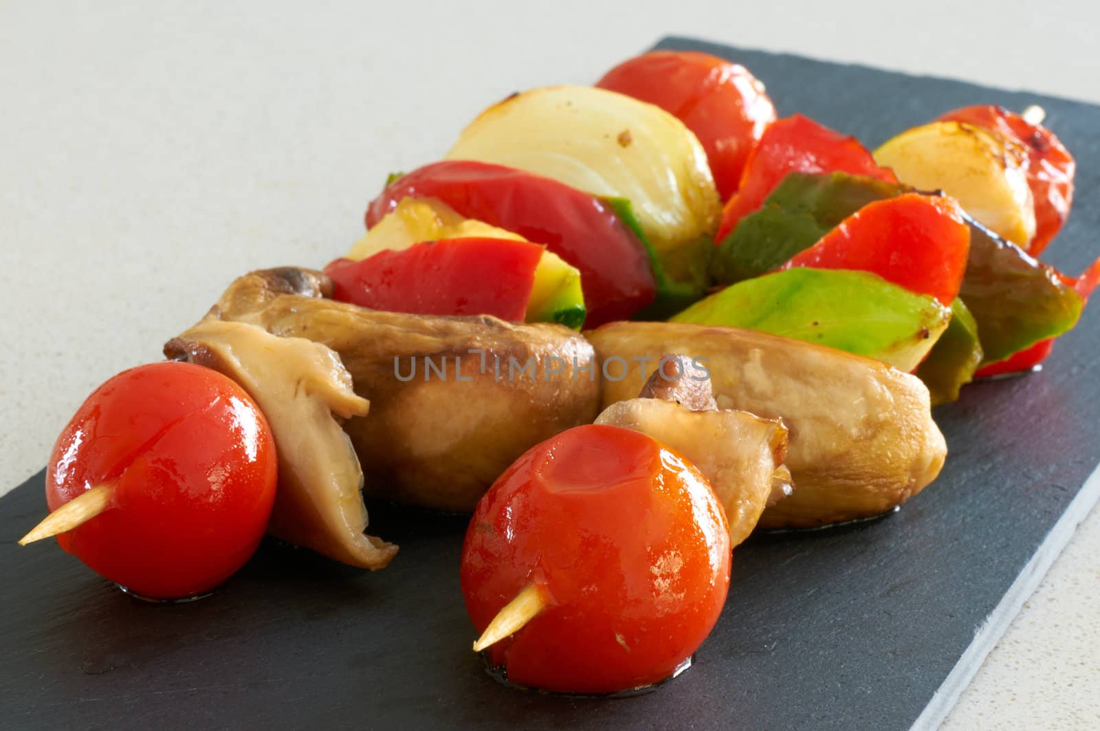 Vegetable brochettes on a black slate tray
