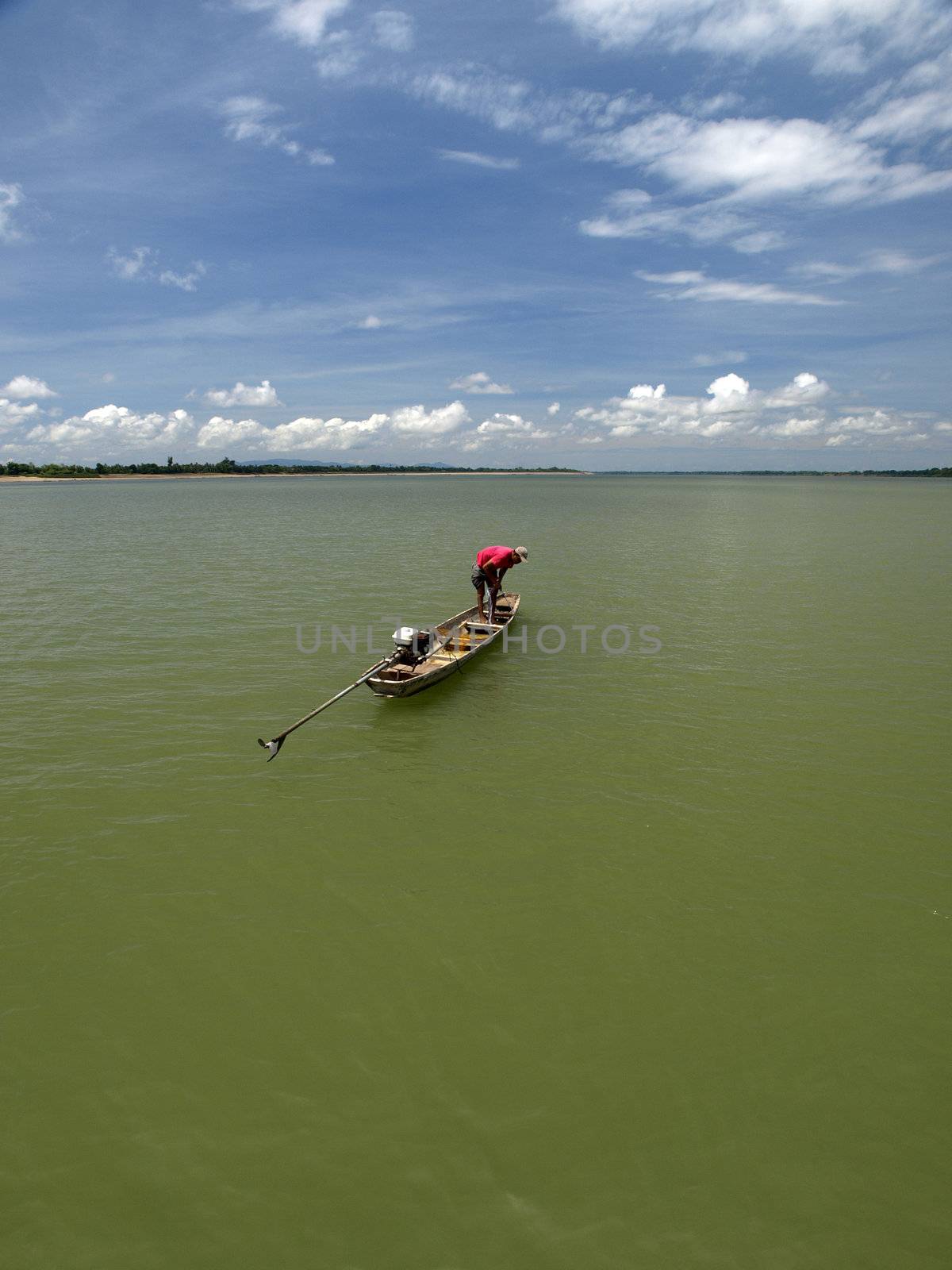Fisherman use his net to catching some fish from Mekong river in southern Laos