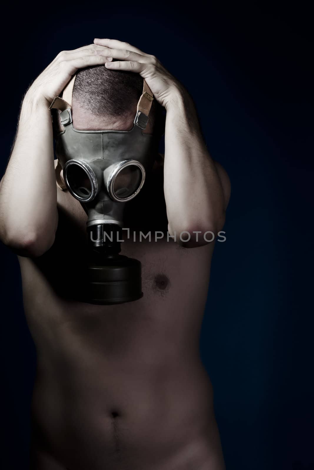 Fear, handsome man with bare torso and gas mask