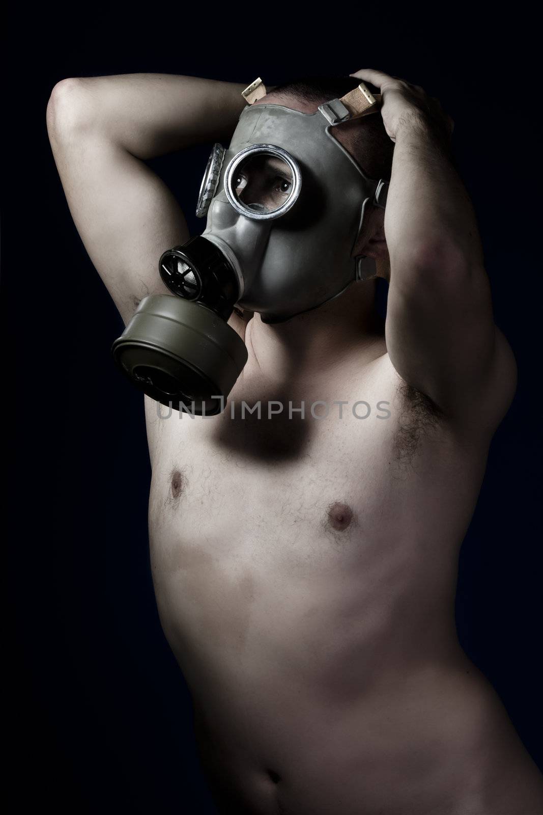 Fear, artistic nude man with gas mask
