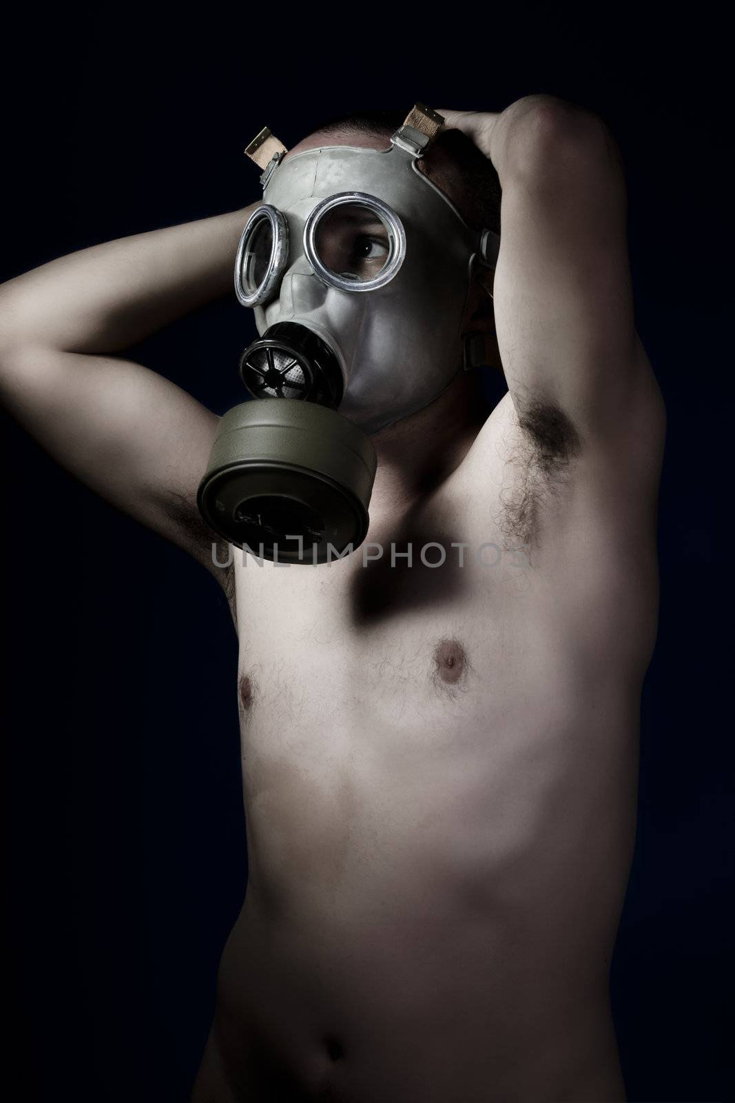 Scared, naked man with gas mask
