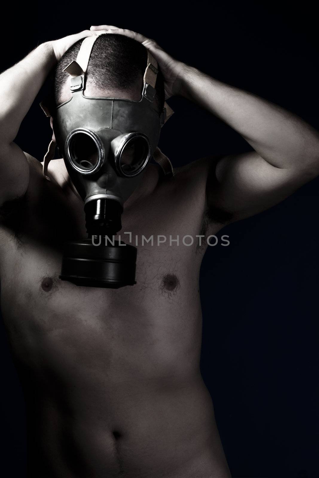 Naked man with protective gas mask, pain, fear, dark