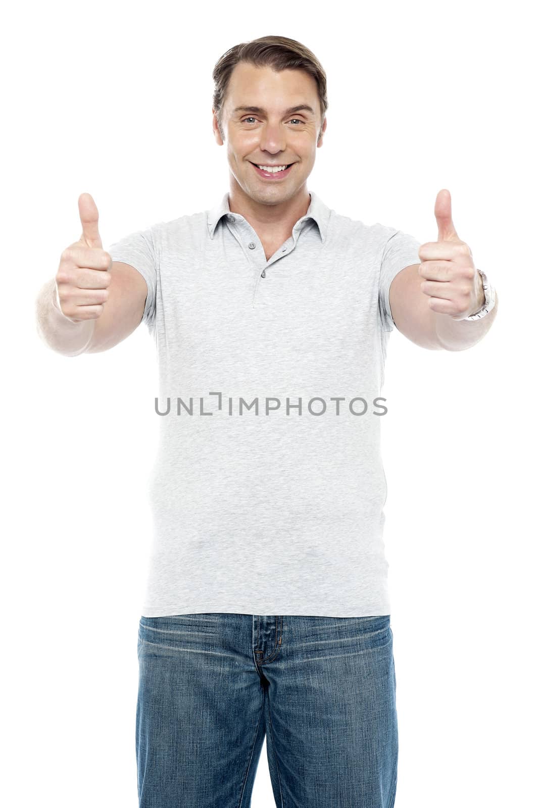 Good looking cheerful man showing double thumbs up to camera