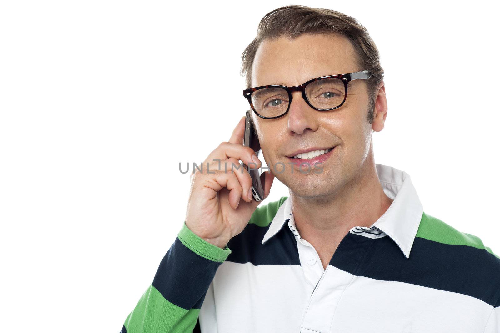Young man communicating via cellphone, closeup shot. Looking at you