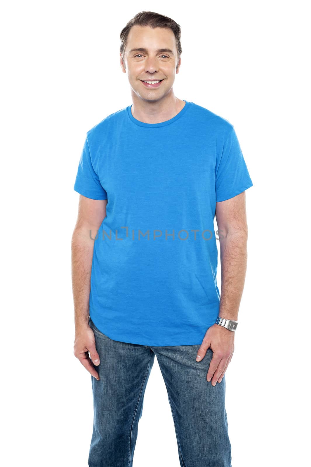 Cheerful calm male model posing in trendy casuals against white background