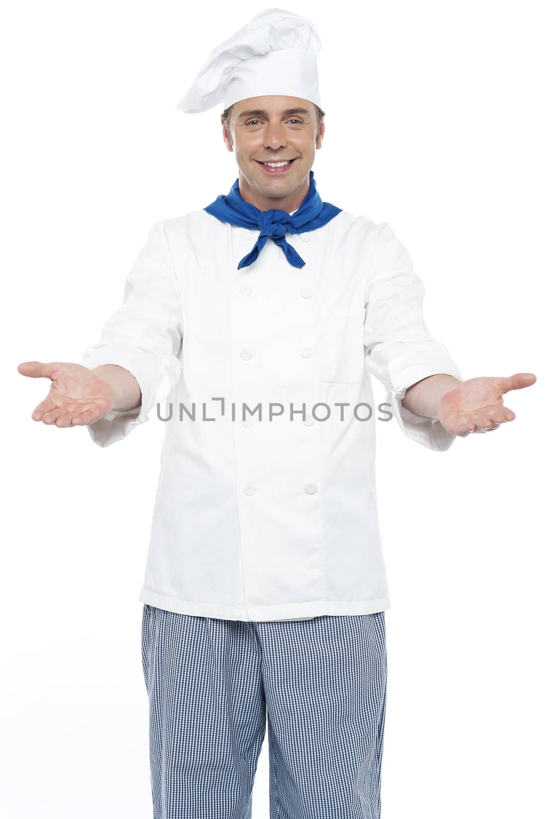 Smiling chef posing with his arms wide open, welcoming guests
