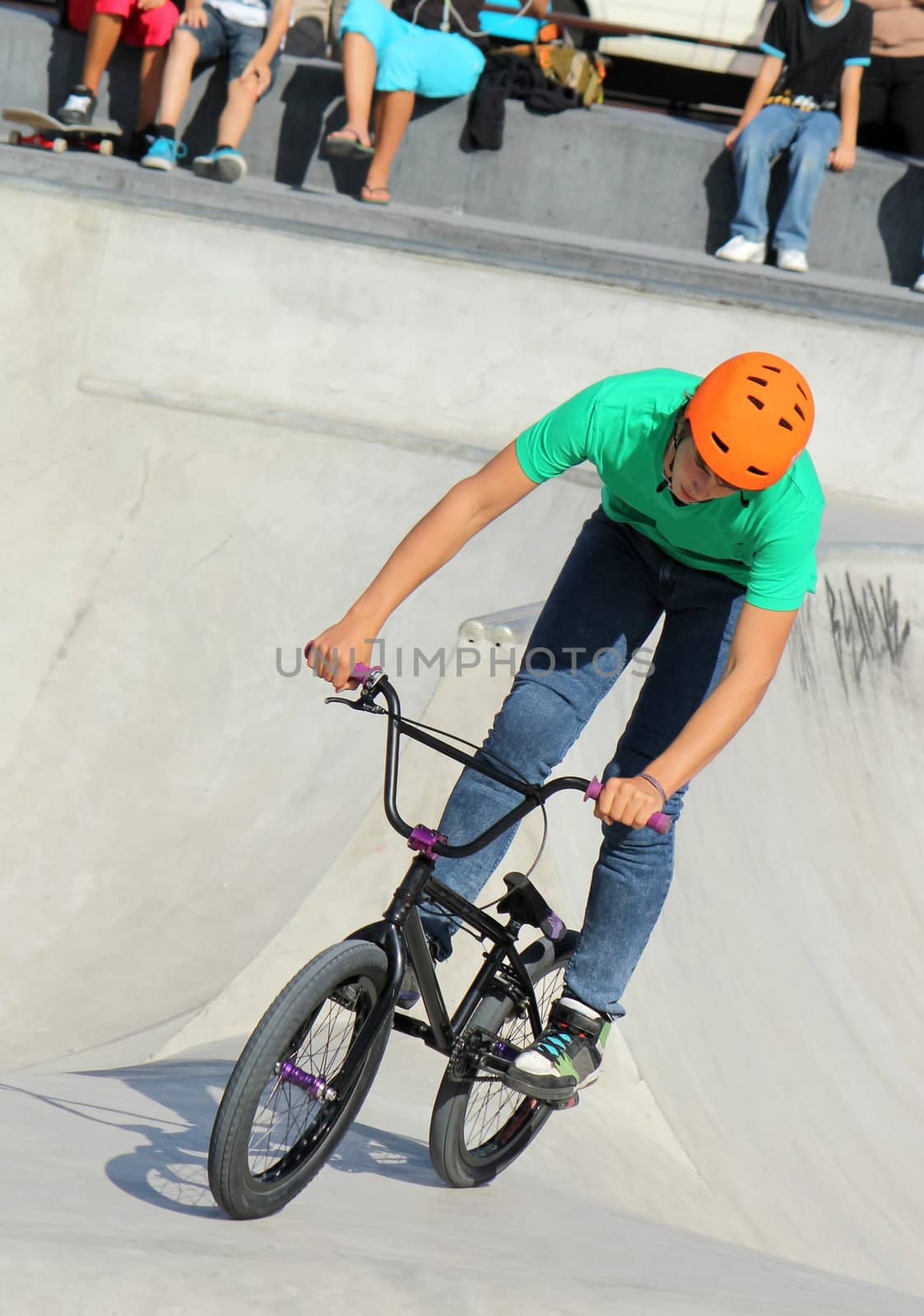 GENEVA, SWITZERLAND - SEPTEMBER 4 : young BMX biker running at the brand new skate park at Plainpalas place, on September 4, 2012 in Geneva, Switzerland.