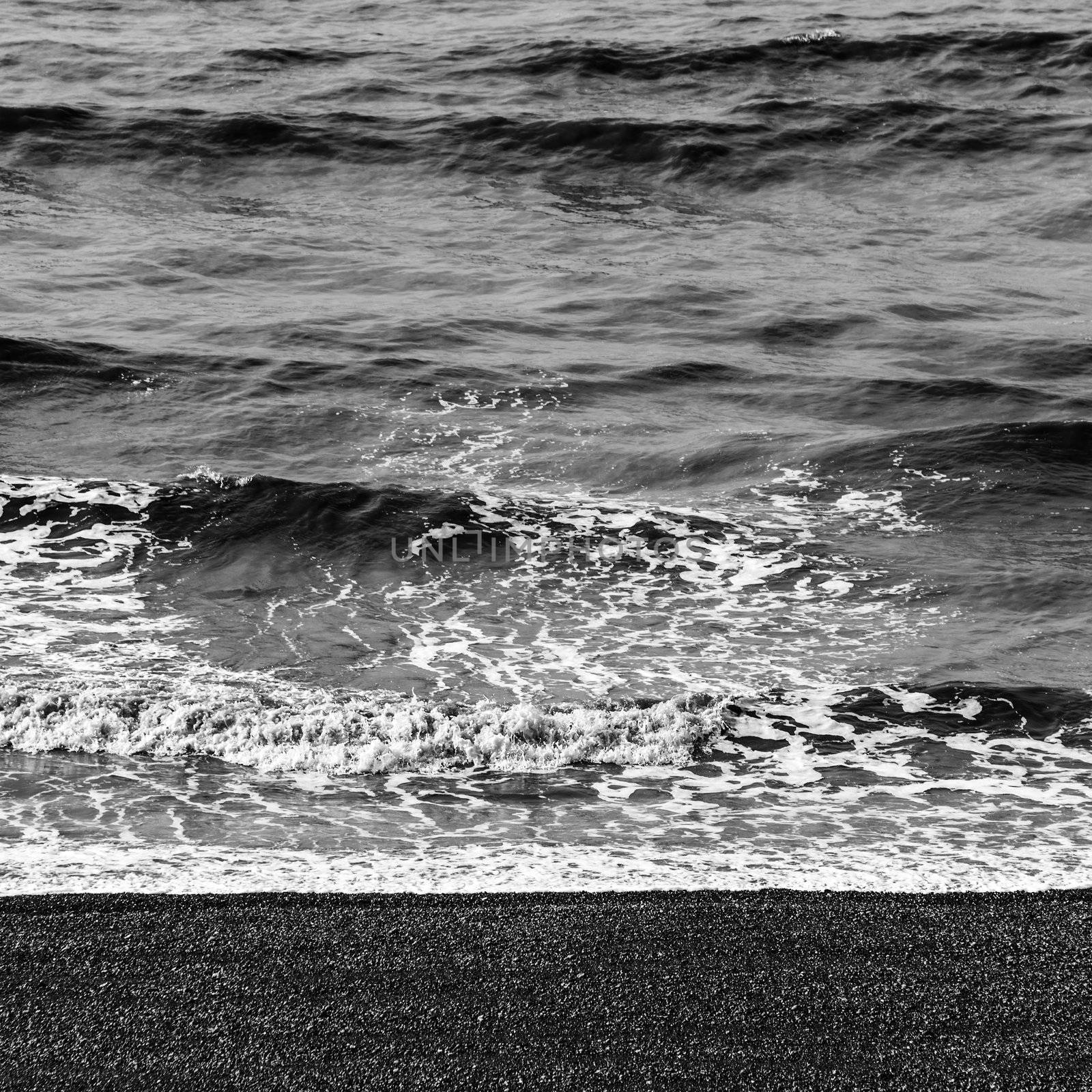 Sea waves and pebble beach in black and white