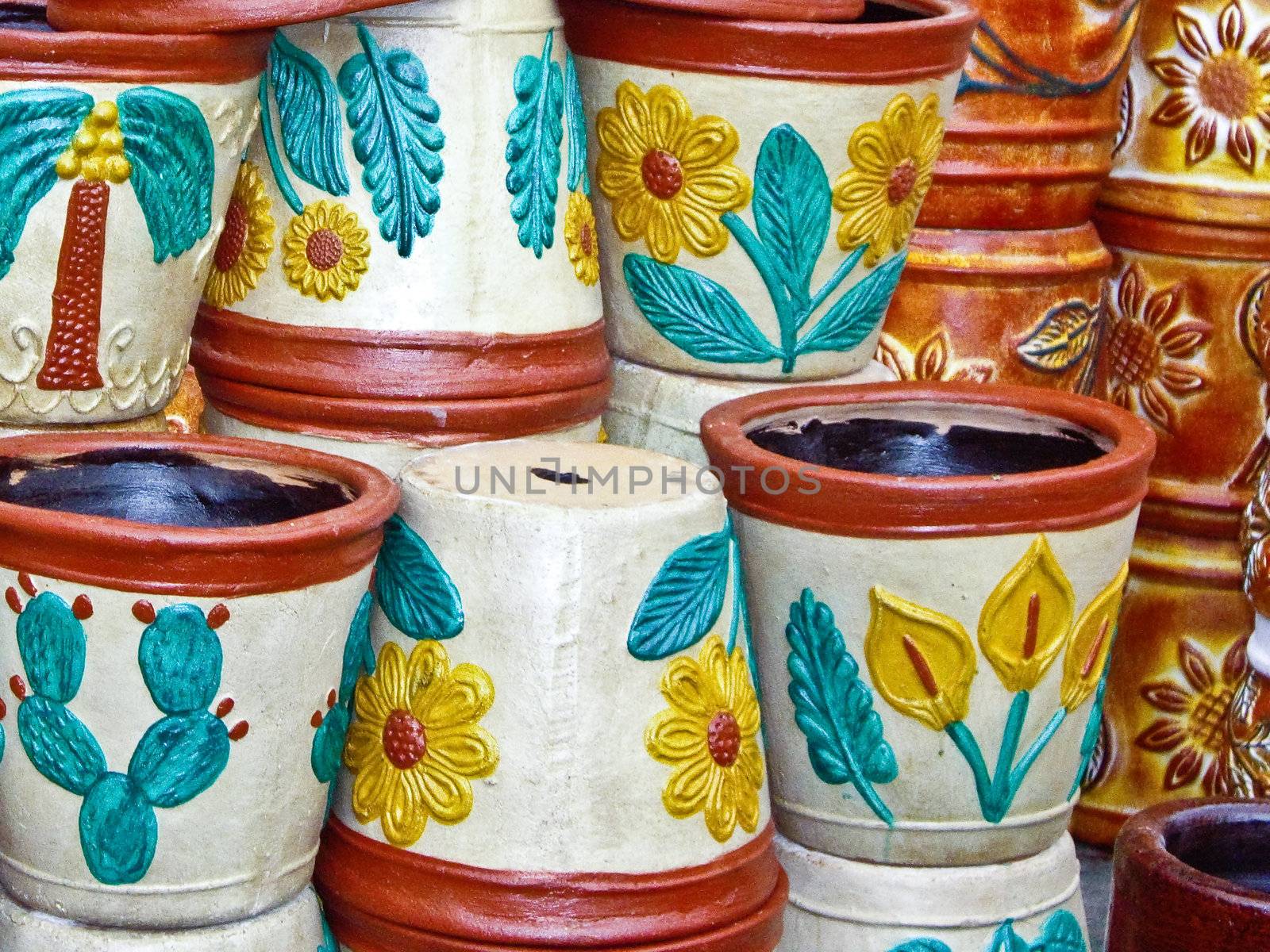 Colorful flowerpots stacked at Mexican market