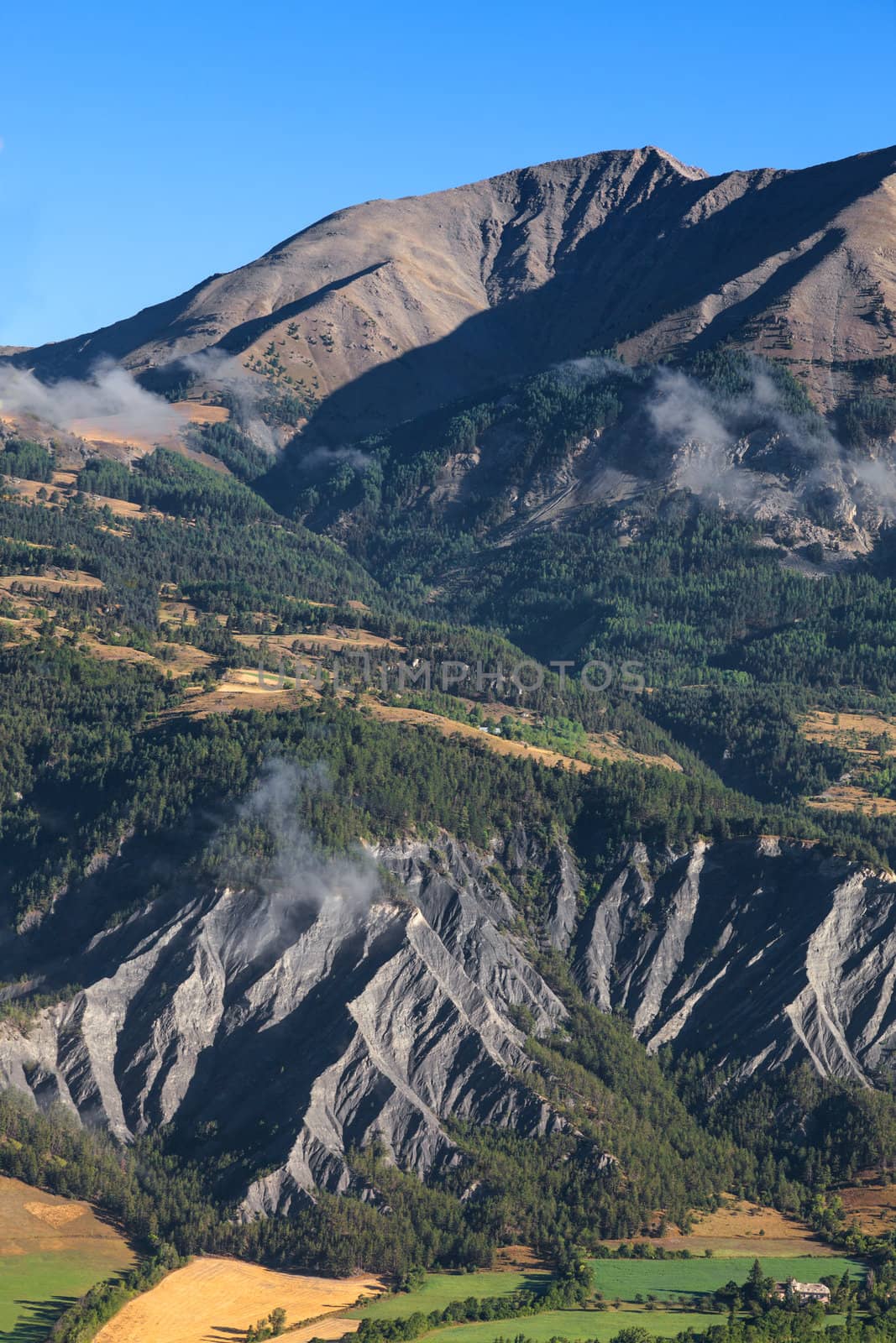 Beautiful landscape with mudslides in the bottom part, located in the Southern French Alps in The Alpes-de-Haute-Provence department.