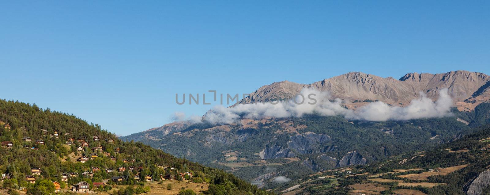 Image of a village located on a high altitude slope with forest in The Southern French Alps in Alpes-de-Haute-Provence region.