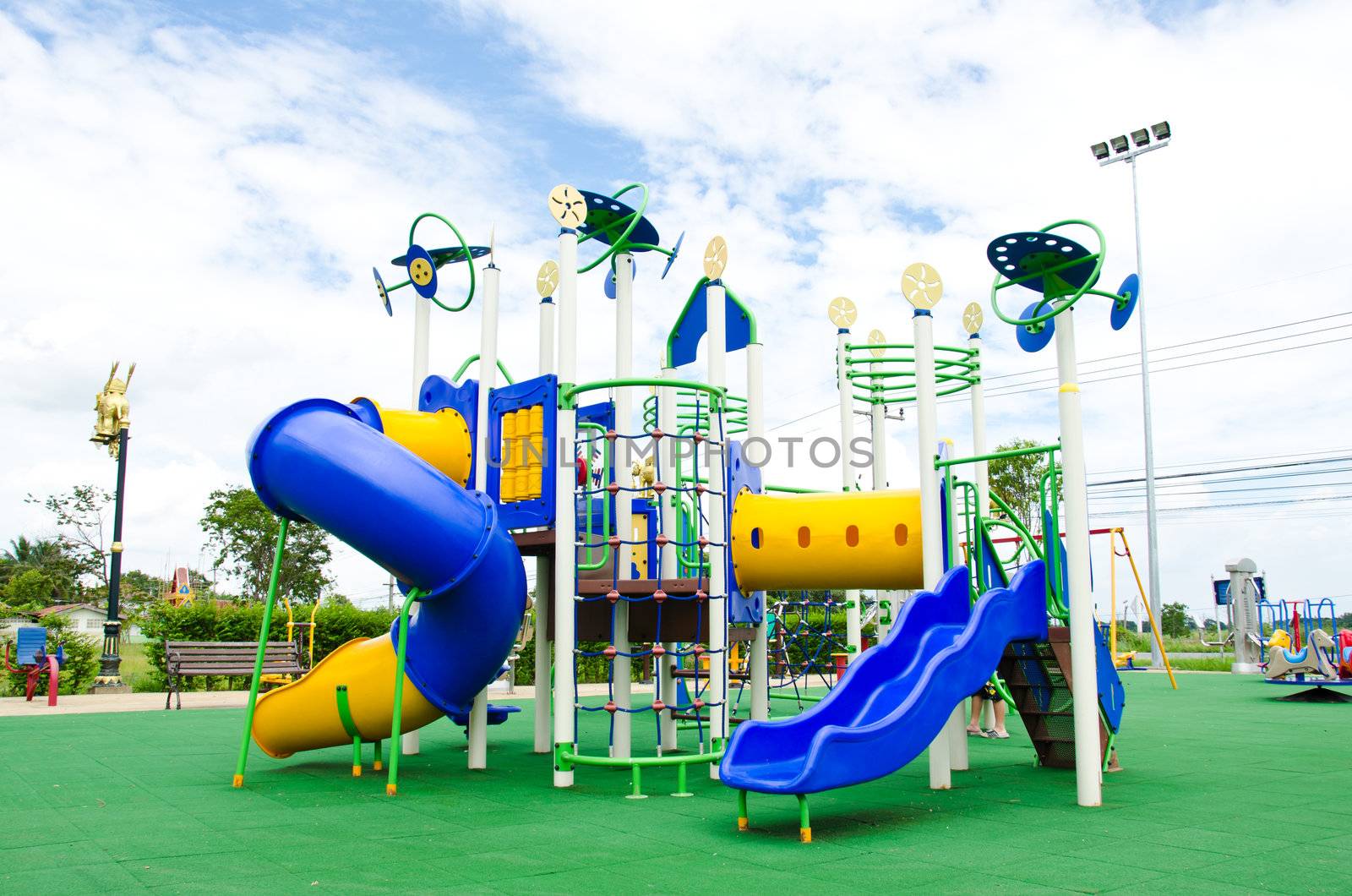 Image of a colorful children's playground in suburban area.