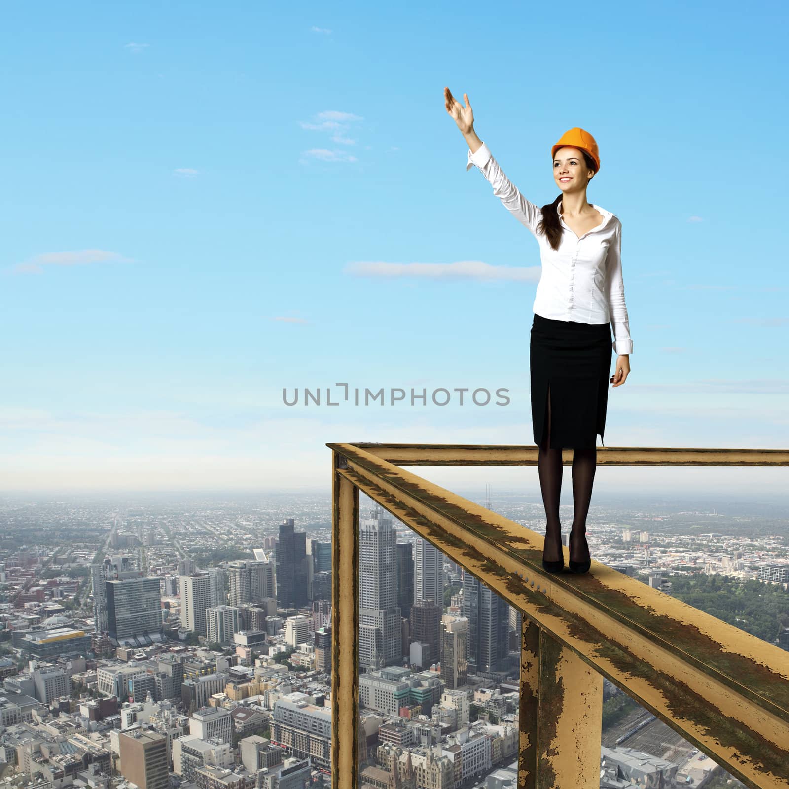 Business woman standing high over a cityscape