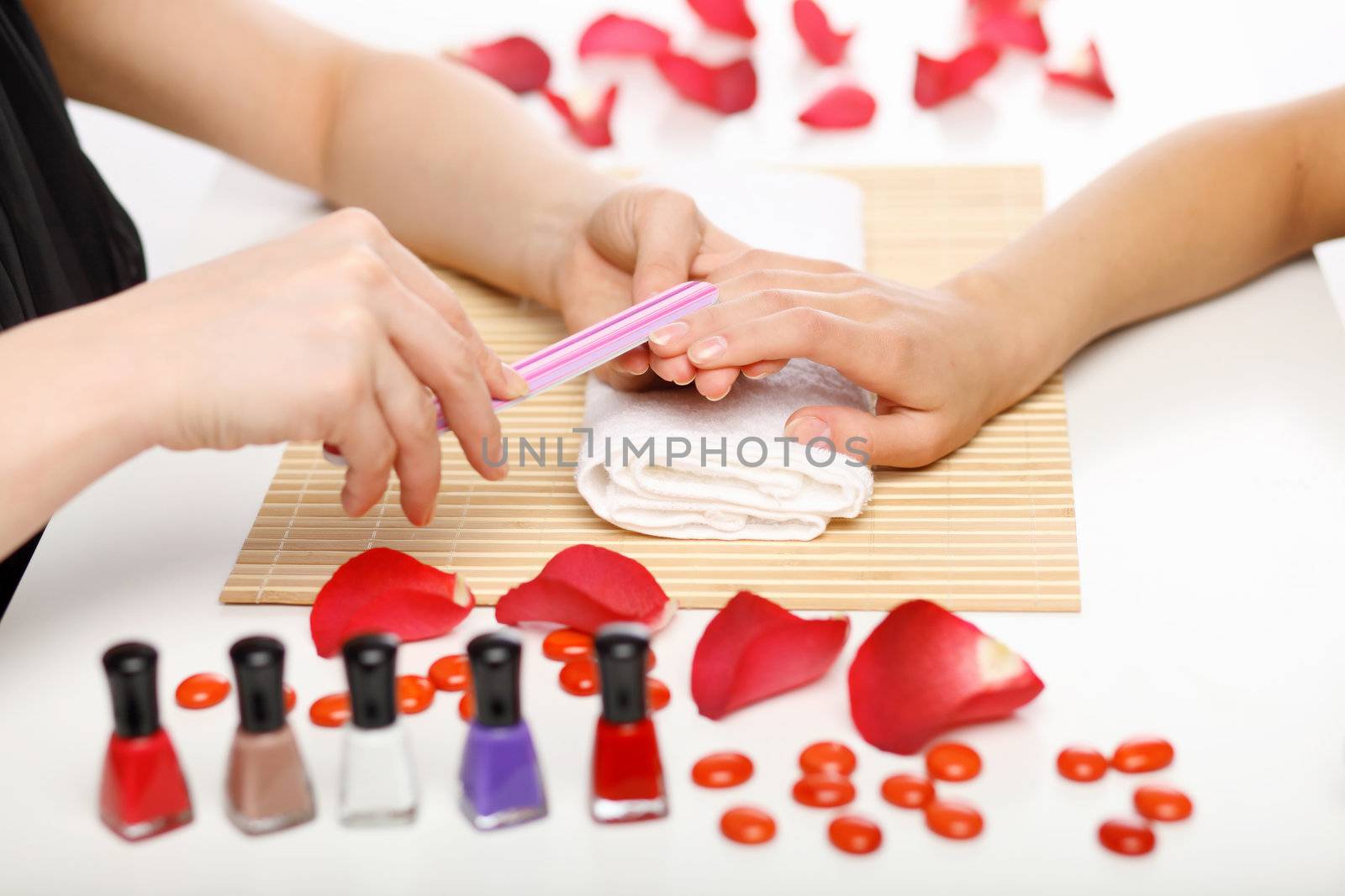 Young woman is getting manicure in a beauty salon