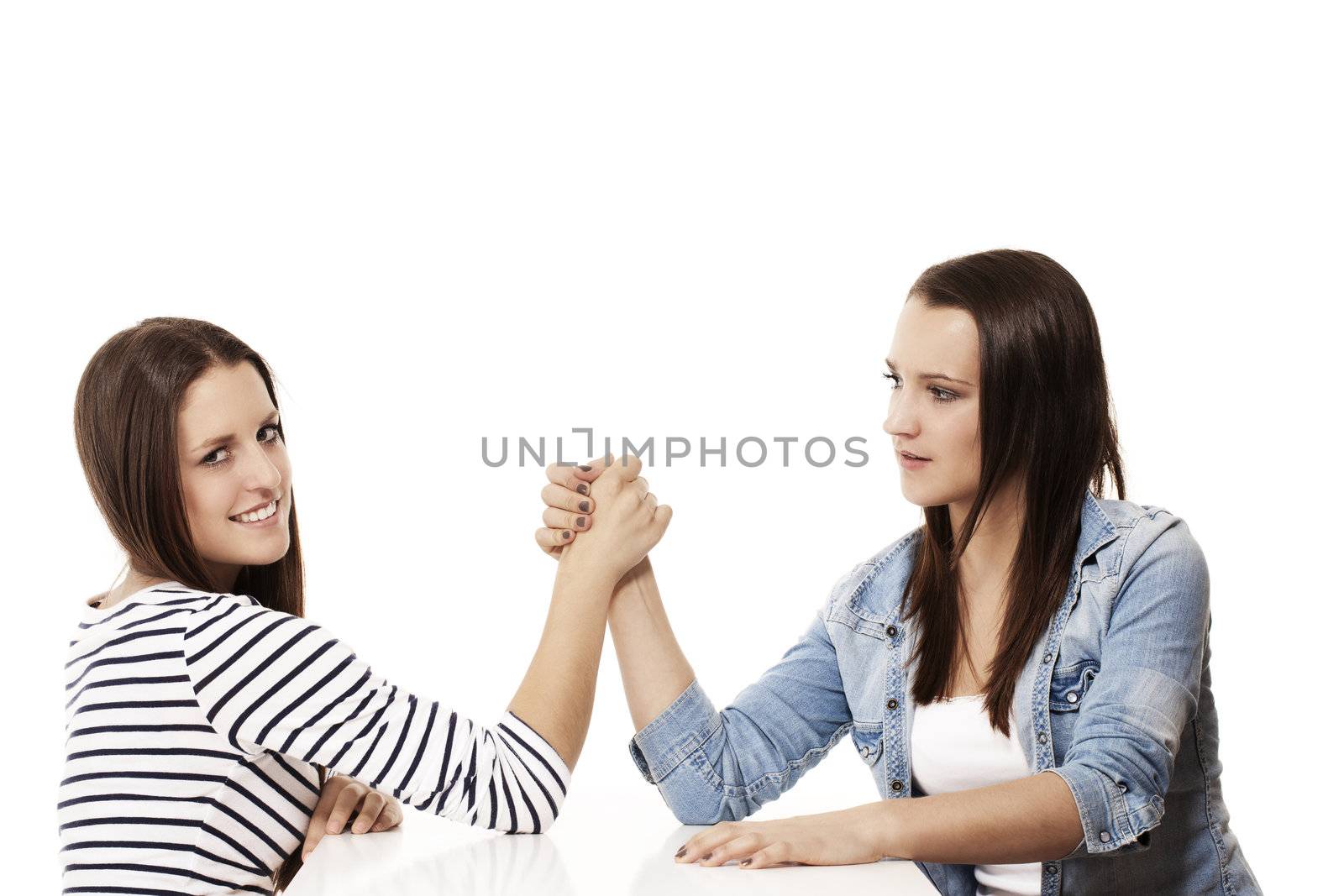 two female arm wrestling teenager on white background