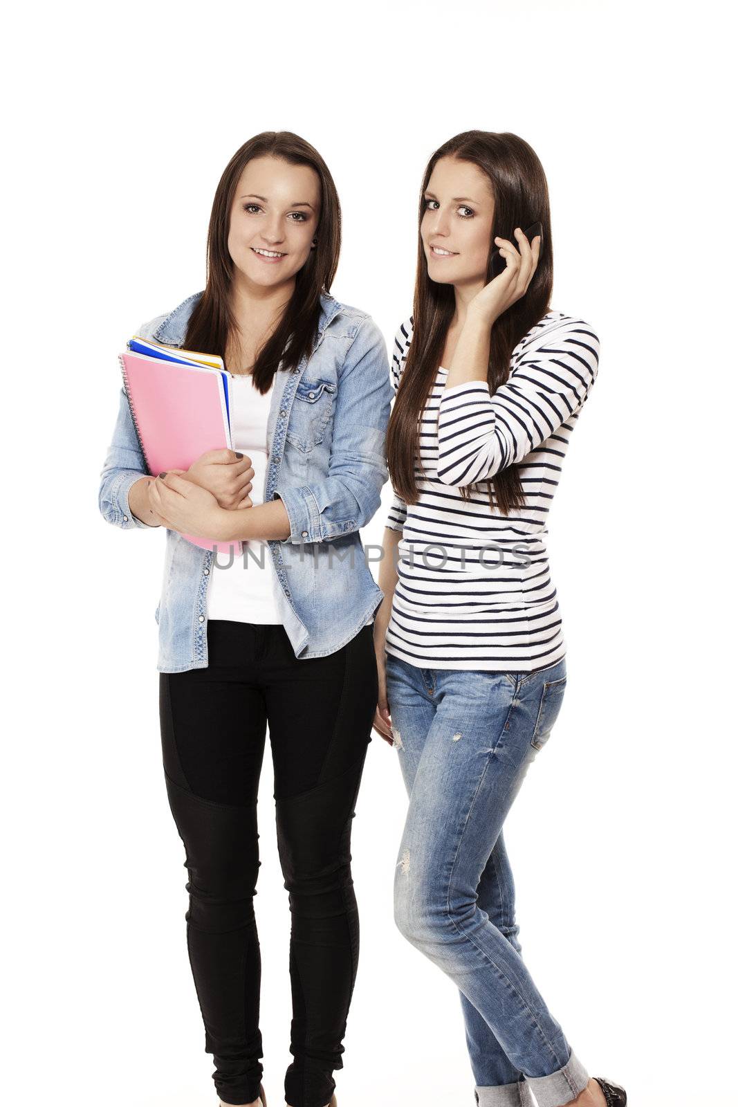 one student calling by phone near her friend with notepads on white background
