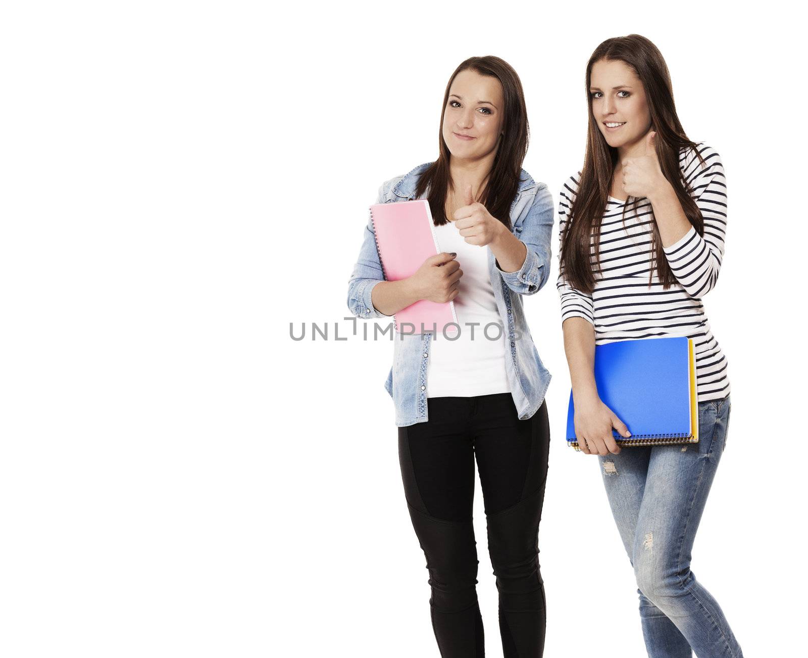 student female teenagers with notepads showing thumbs up on white background