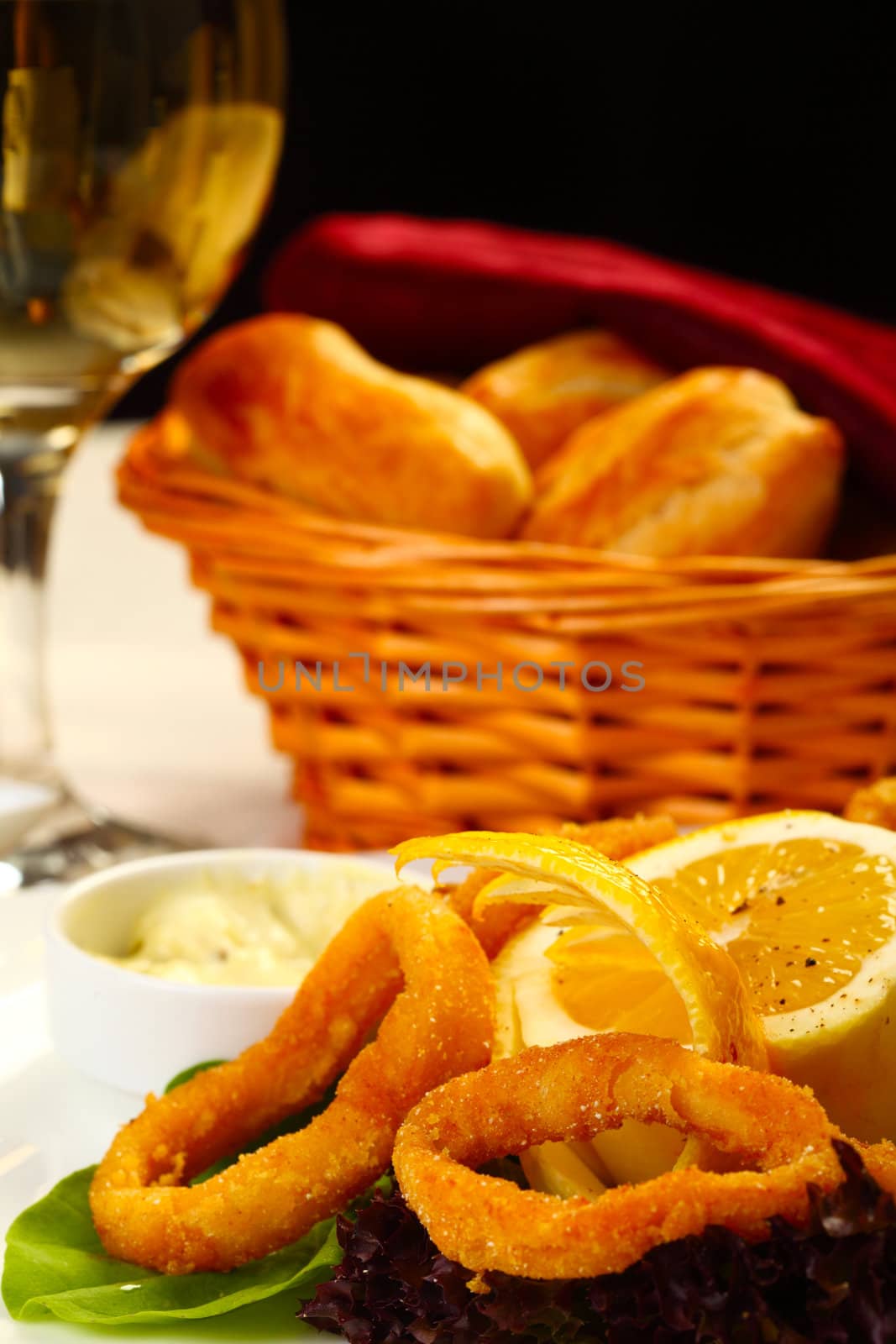 Delicious fried calamars with lemon and salad