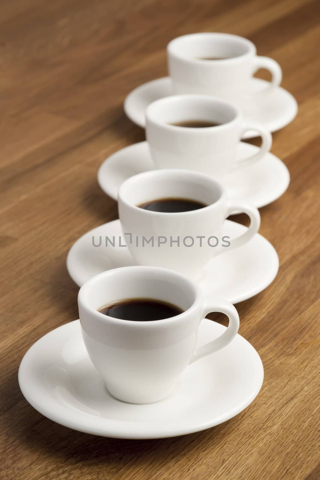 Row of white coffee cups.