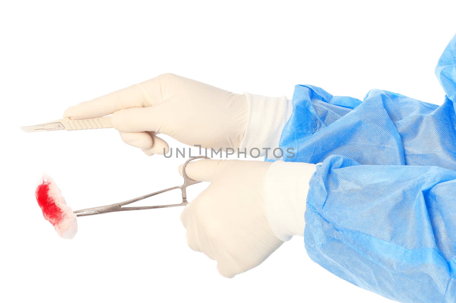 scalpel and clamp with swab in the hand of the surgeon during a surgery