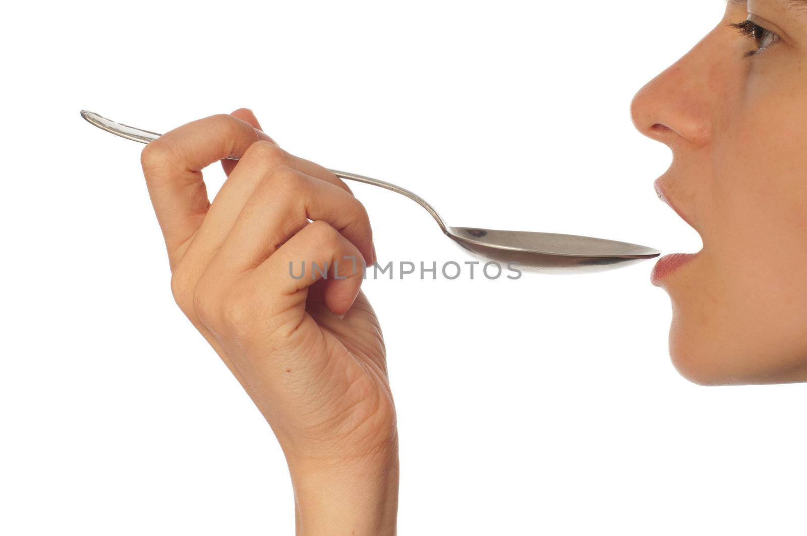 woman holding tablespoon in the hand for feeding a sick person