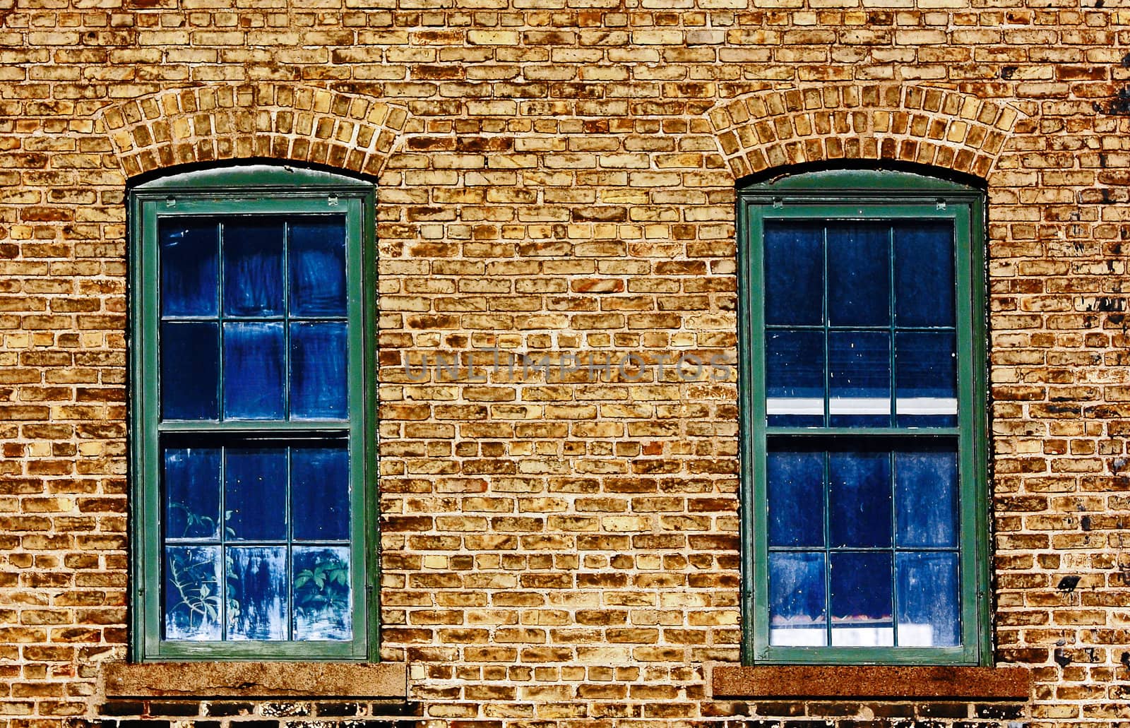 Two Blue Windows on an old Brice Wall