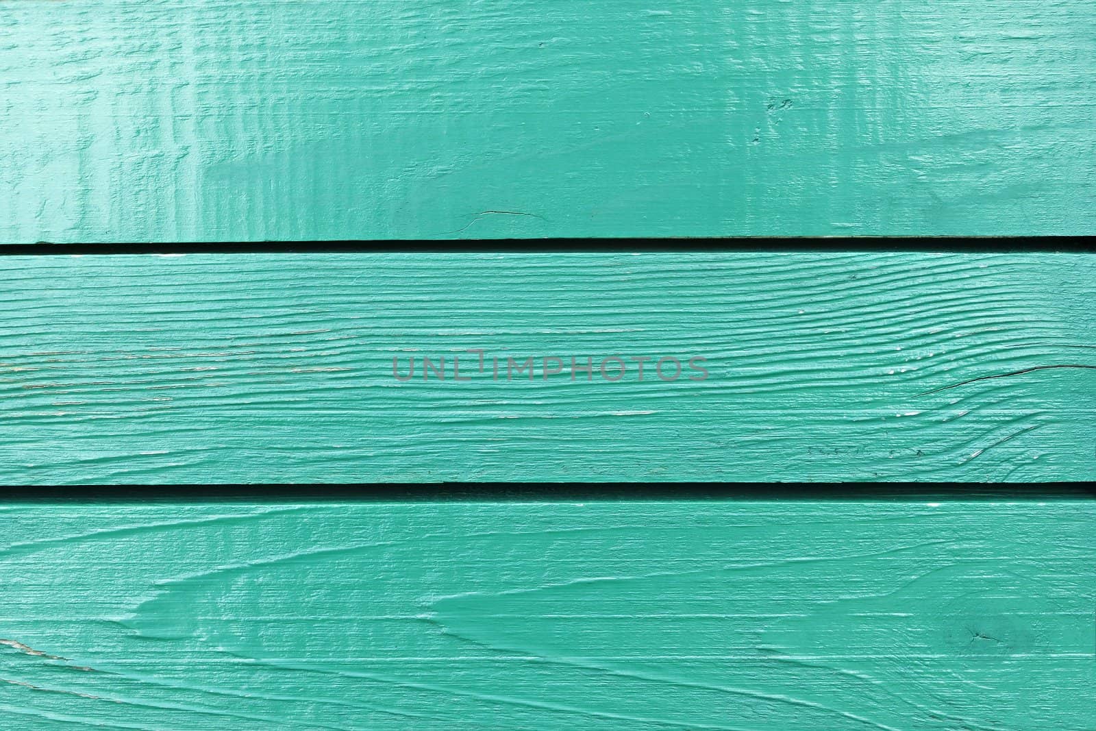 Fragment of wooden fence painted in bright aquamarine