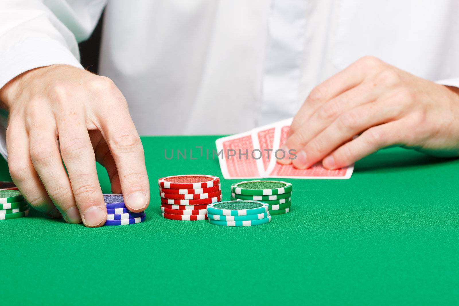 Man with cards on a gambling table