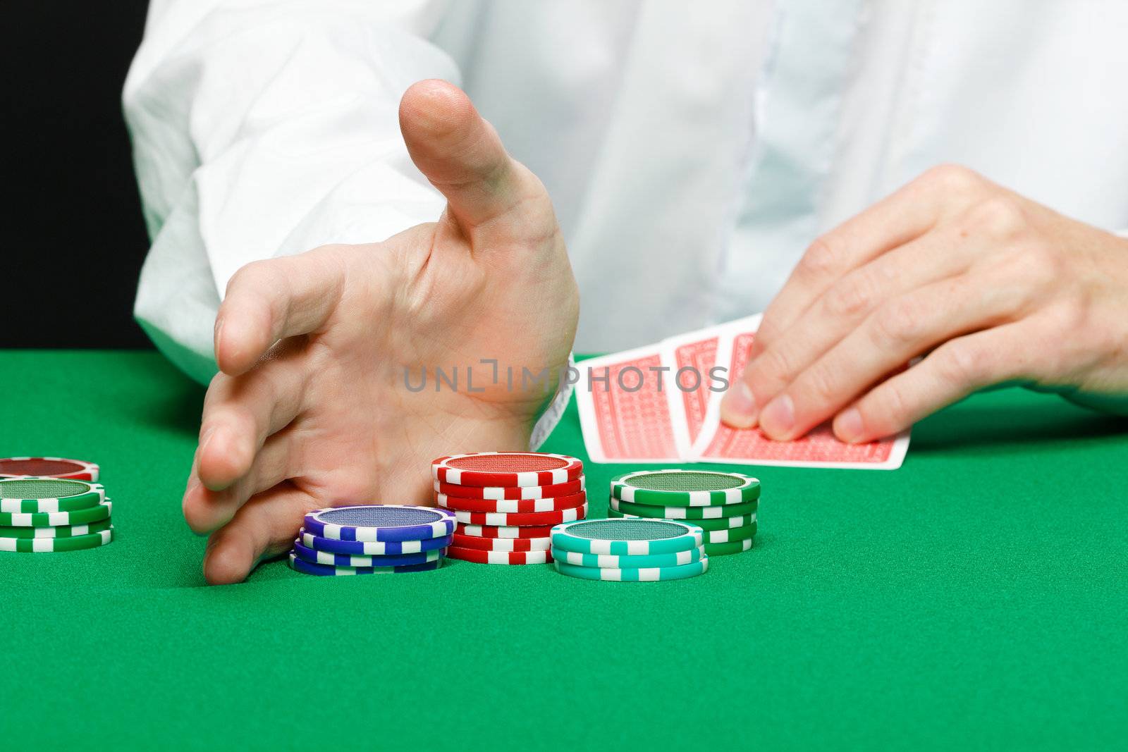 casino. Man's hand with cards and chips on a gambling table