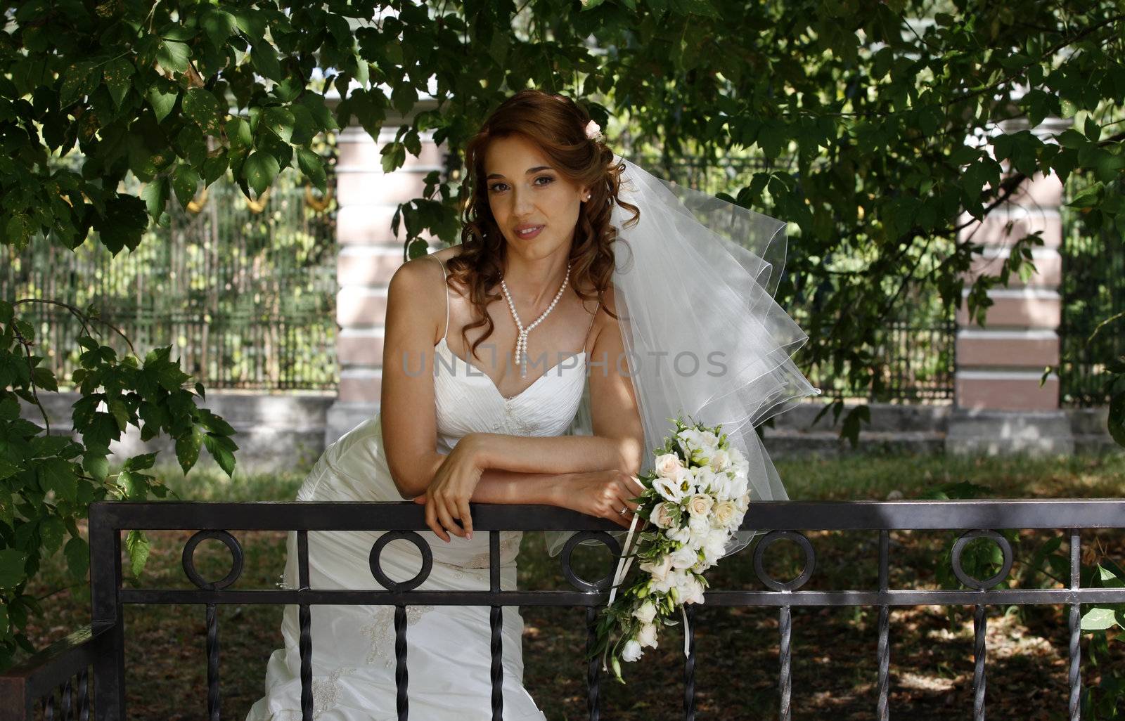 The beautiful bride on a green background