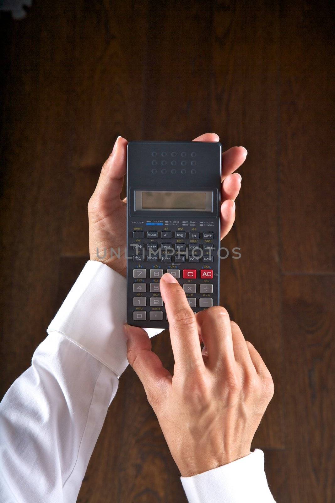 hand detail with a scientific calculator in her hands
