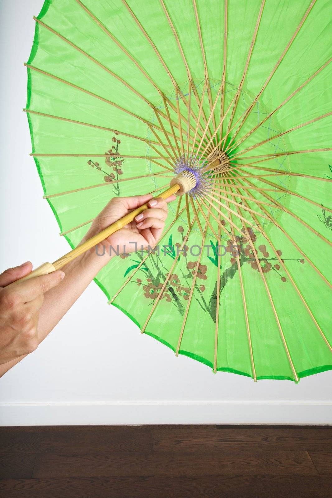 woman with asian umbrella on wood floor indoor