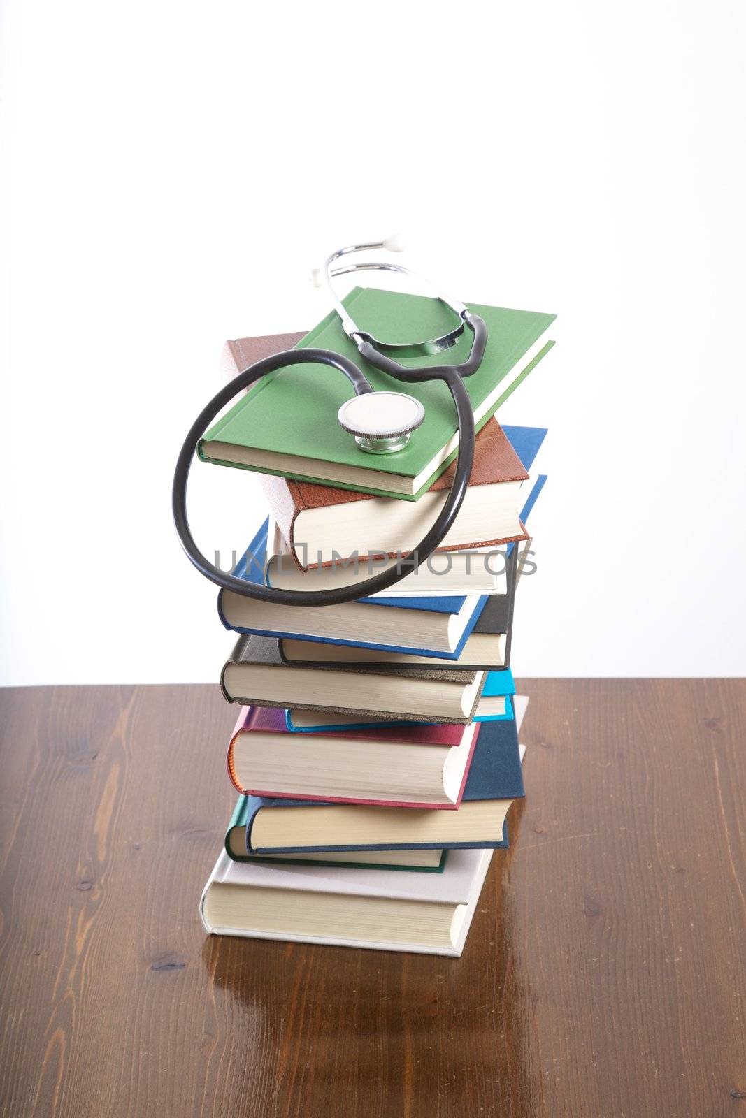 group of books piled on table and white background
