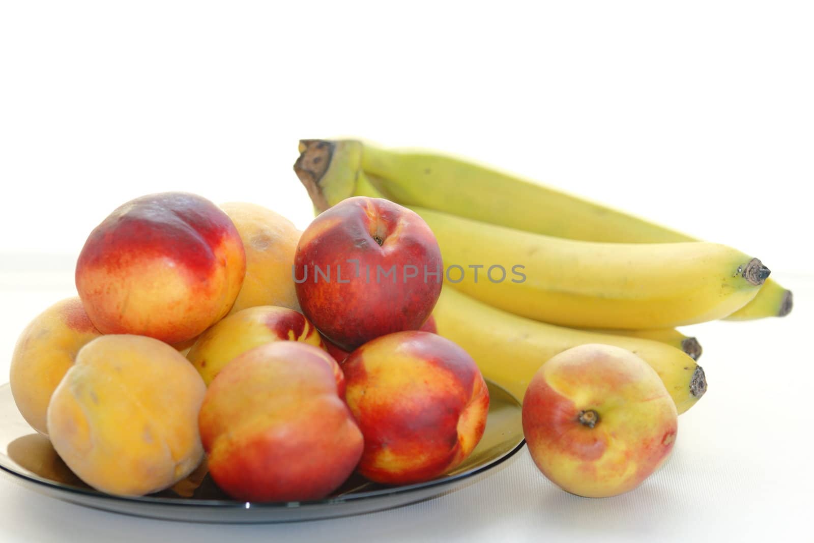 beautiful, delicious peaches, bananas on a light background
