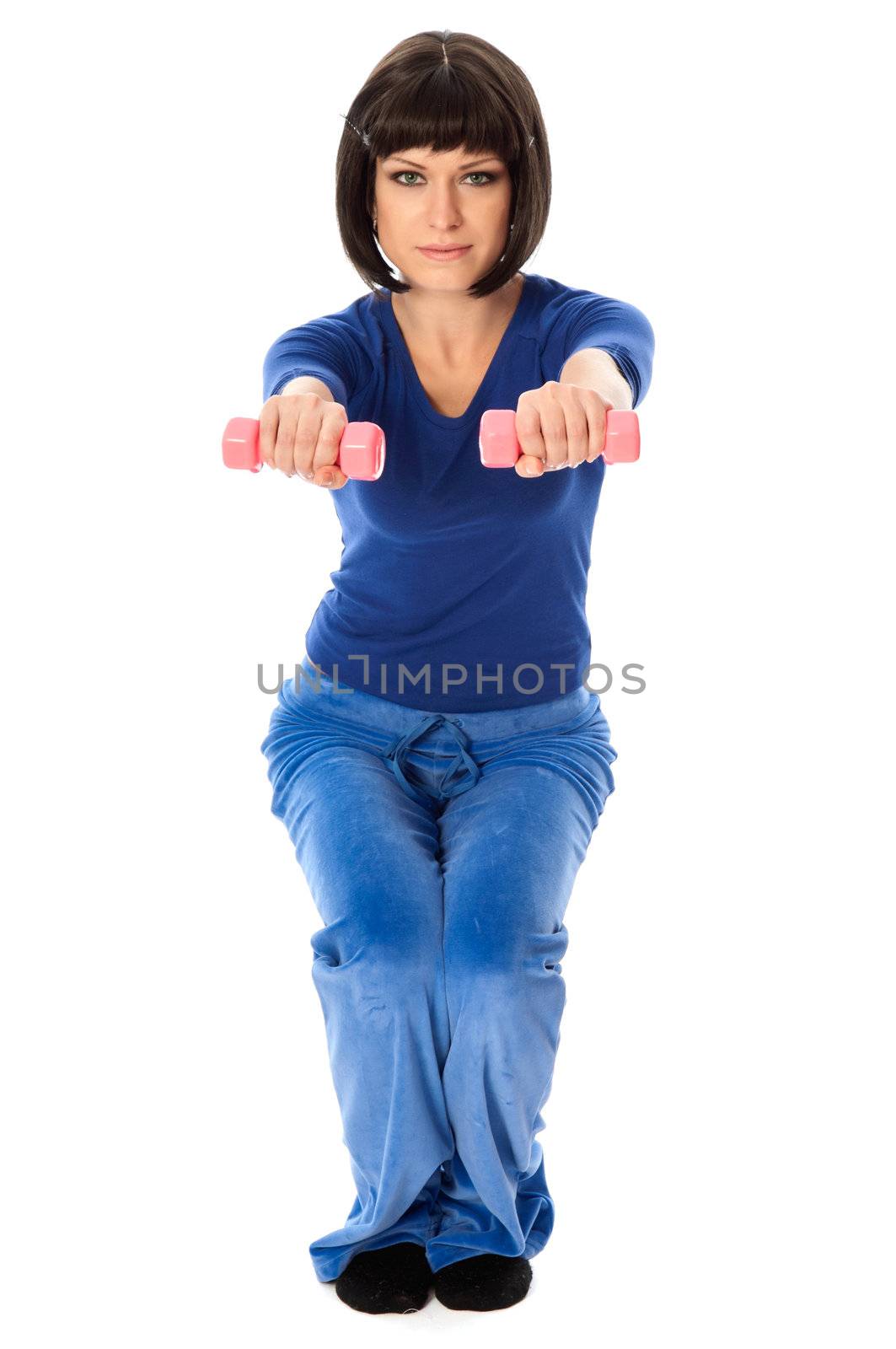 instructor showing to people exercises using dumbbells at gym