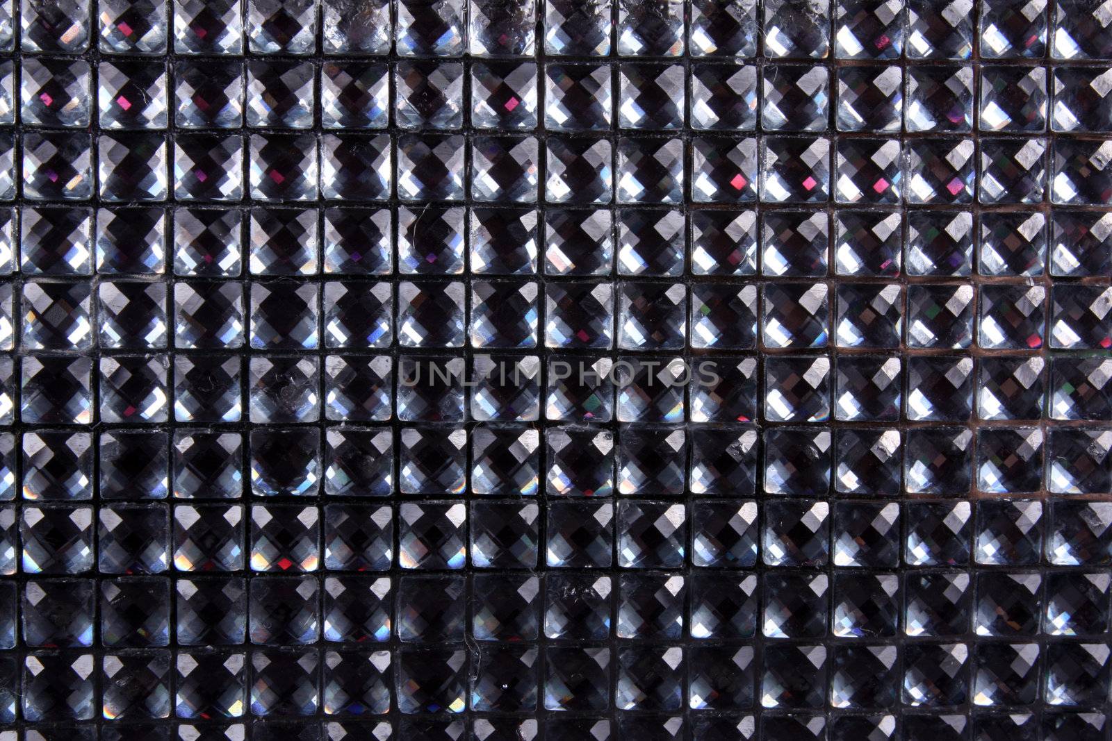 A background of sparkling artificial square shaped gemstones.