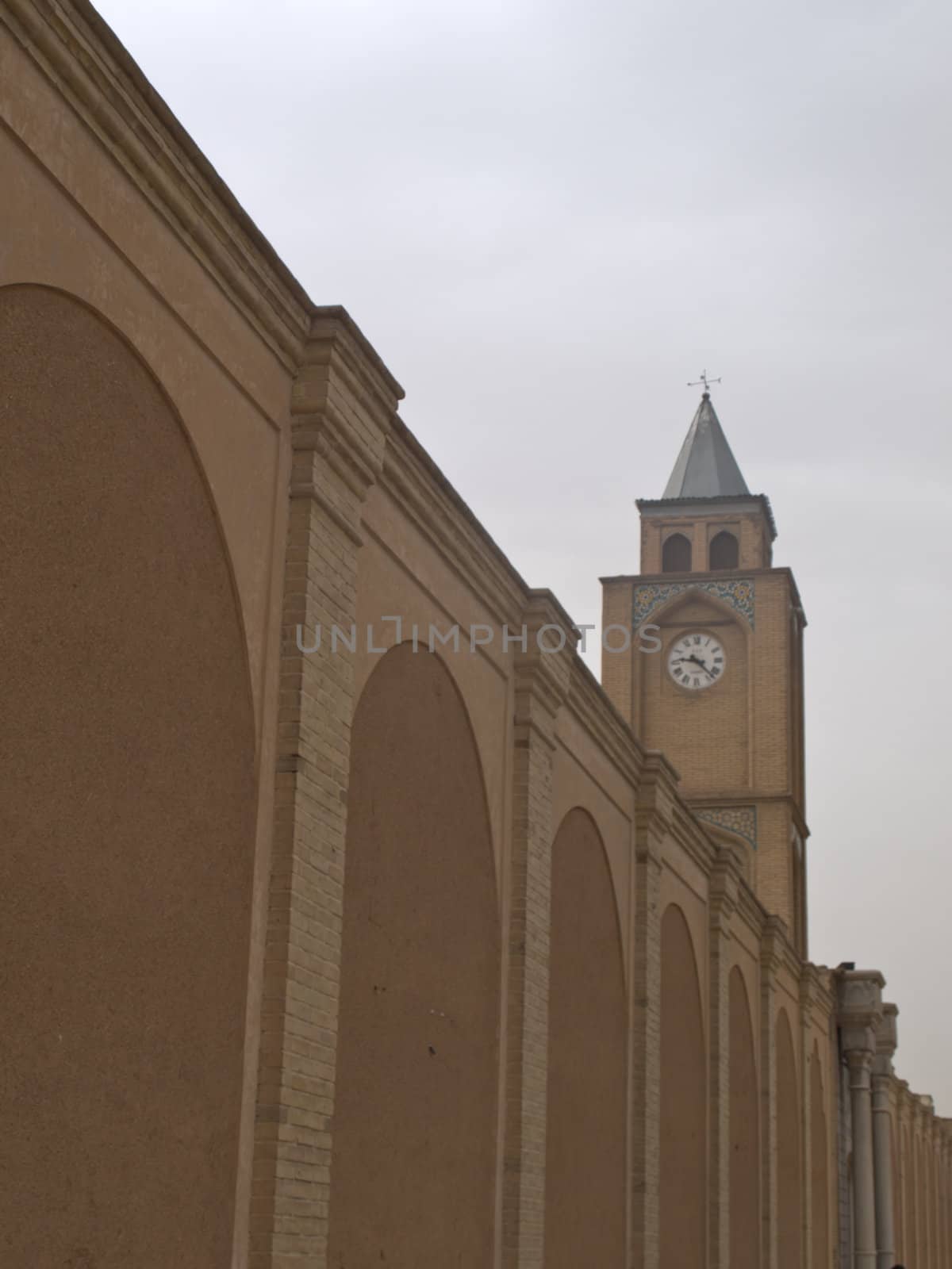 Vank Cathedral clock tower and brick wall in Isfahan Iran by gururugu