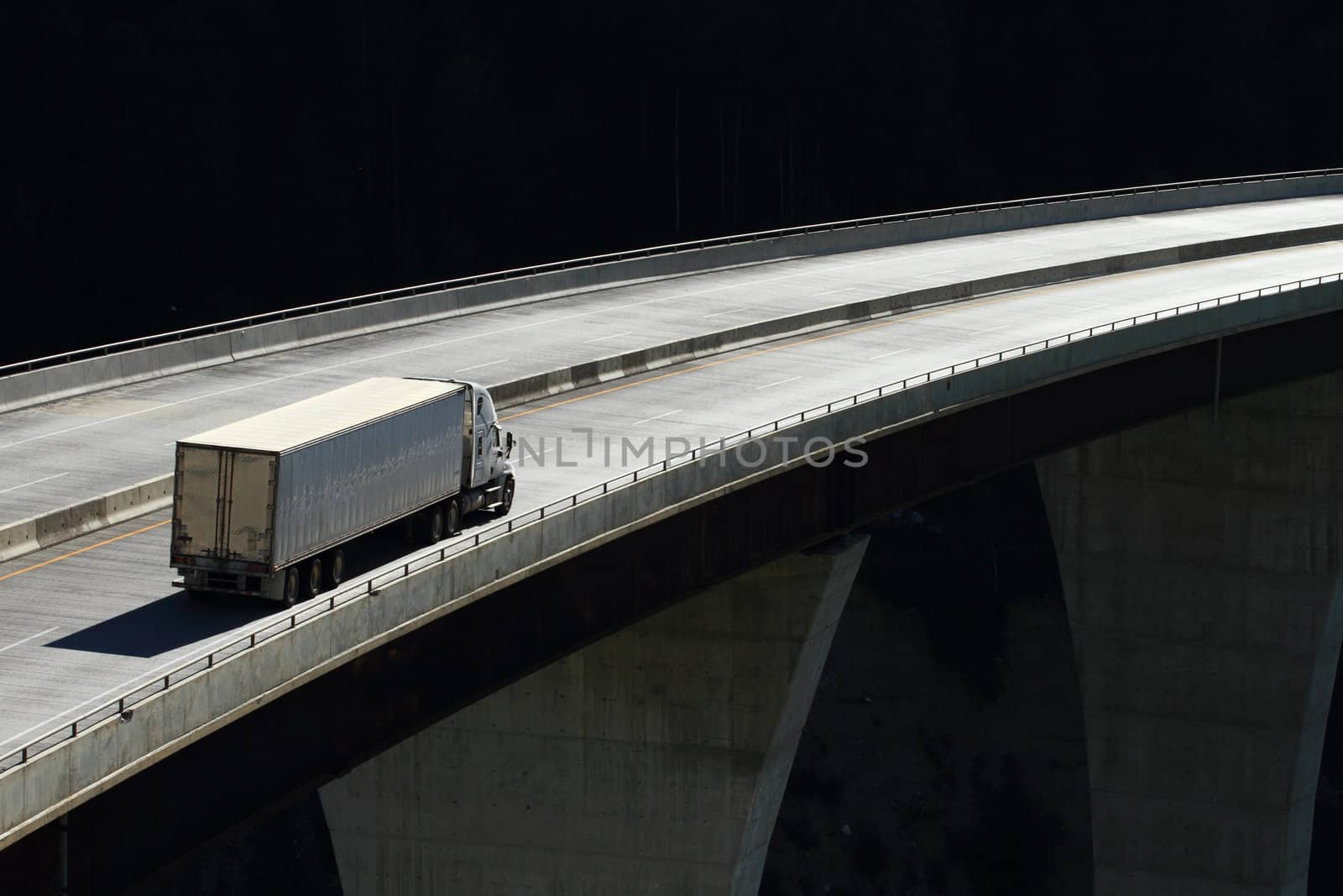 Semi trailer truck crossing a high level bridge in British Columbia, Canada
