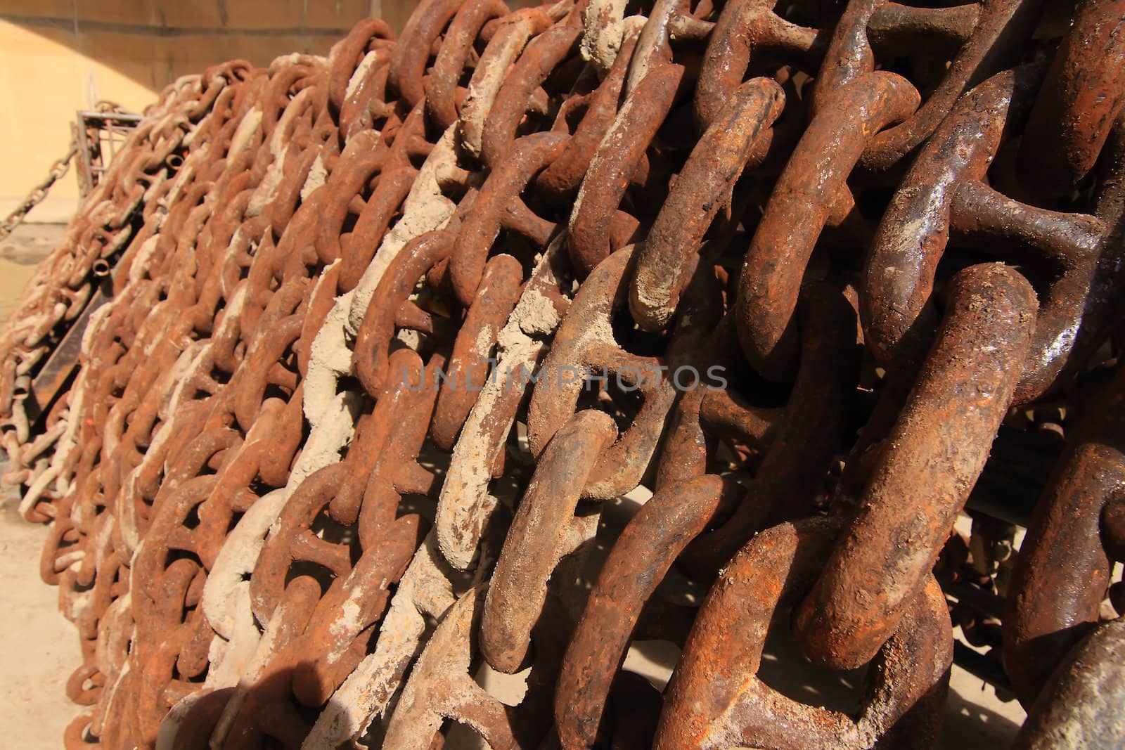 Old rusty ship anchor chain links close up.