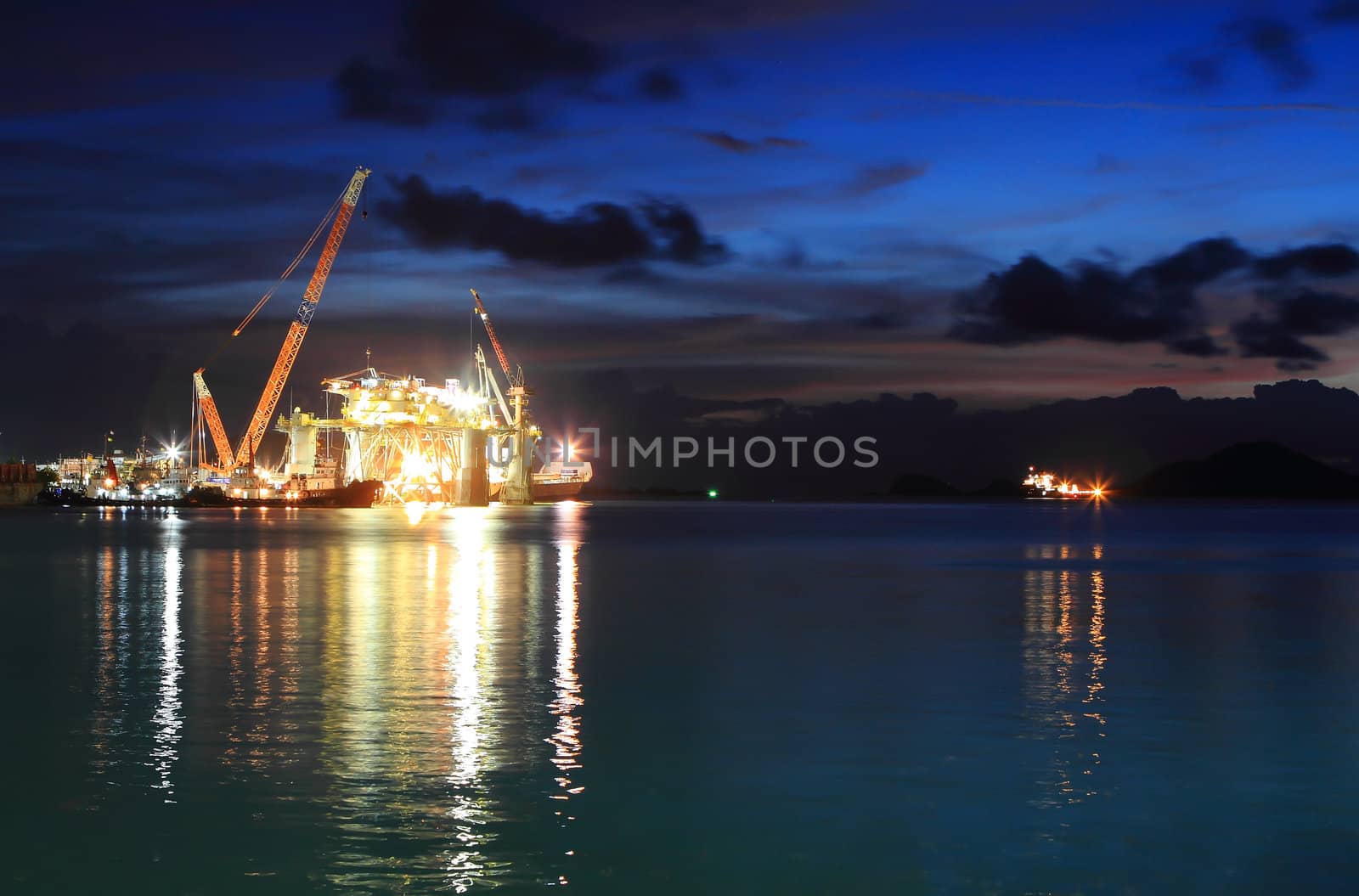 Silhouette of dock- and shipbuilding company at sunset by rufous
