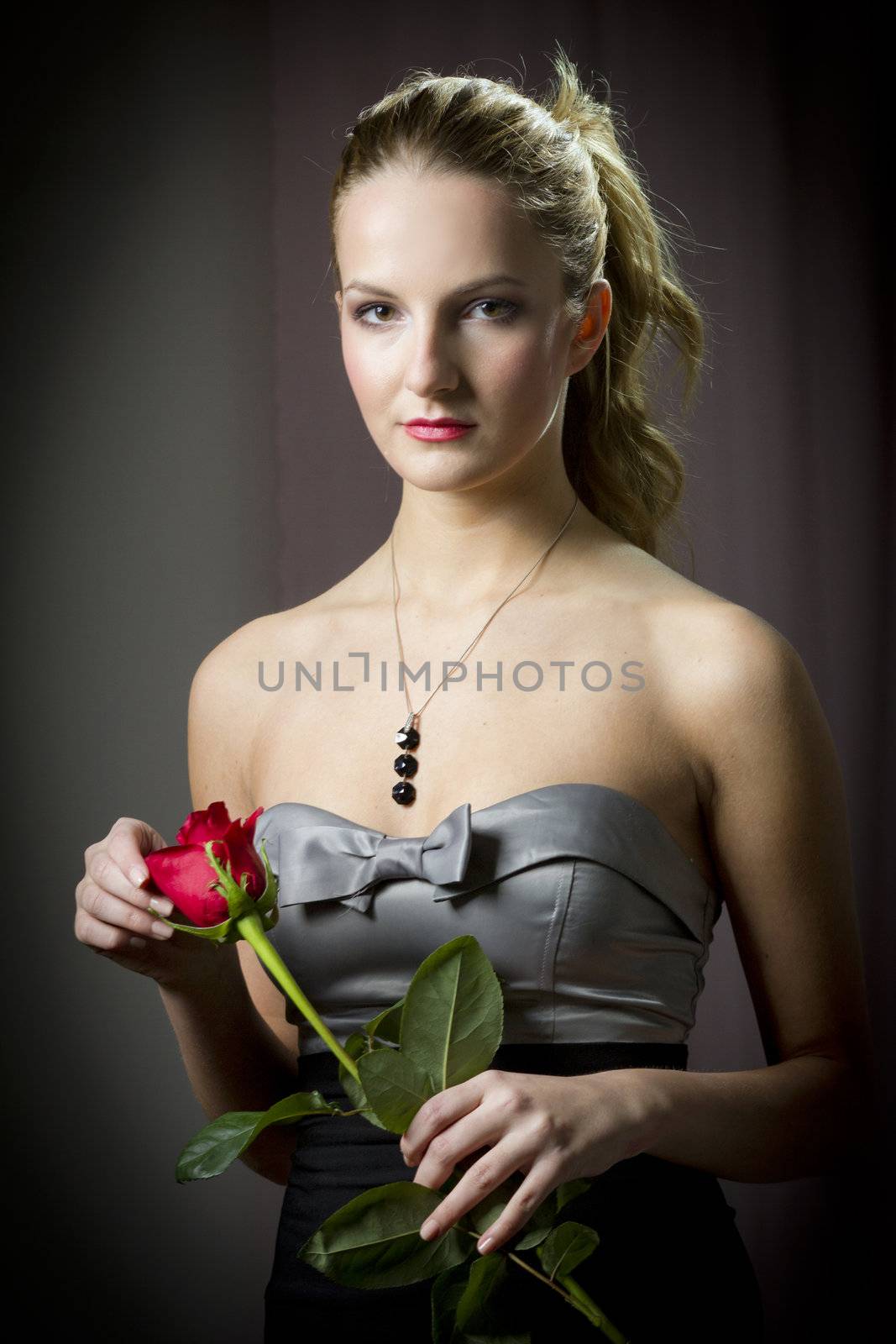 Attractive woman holding a rose on Valentine's day,