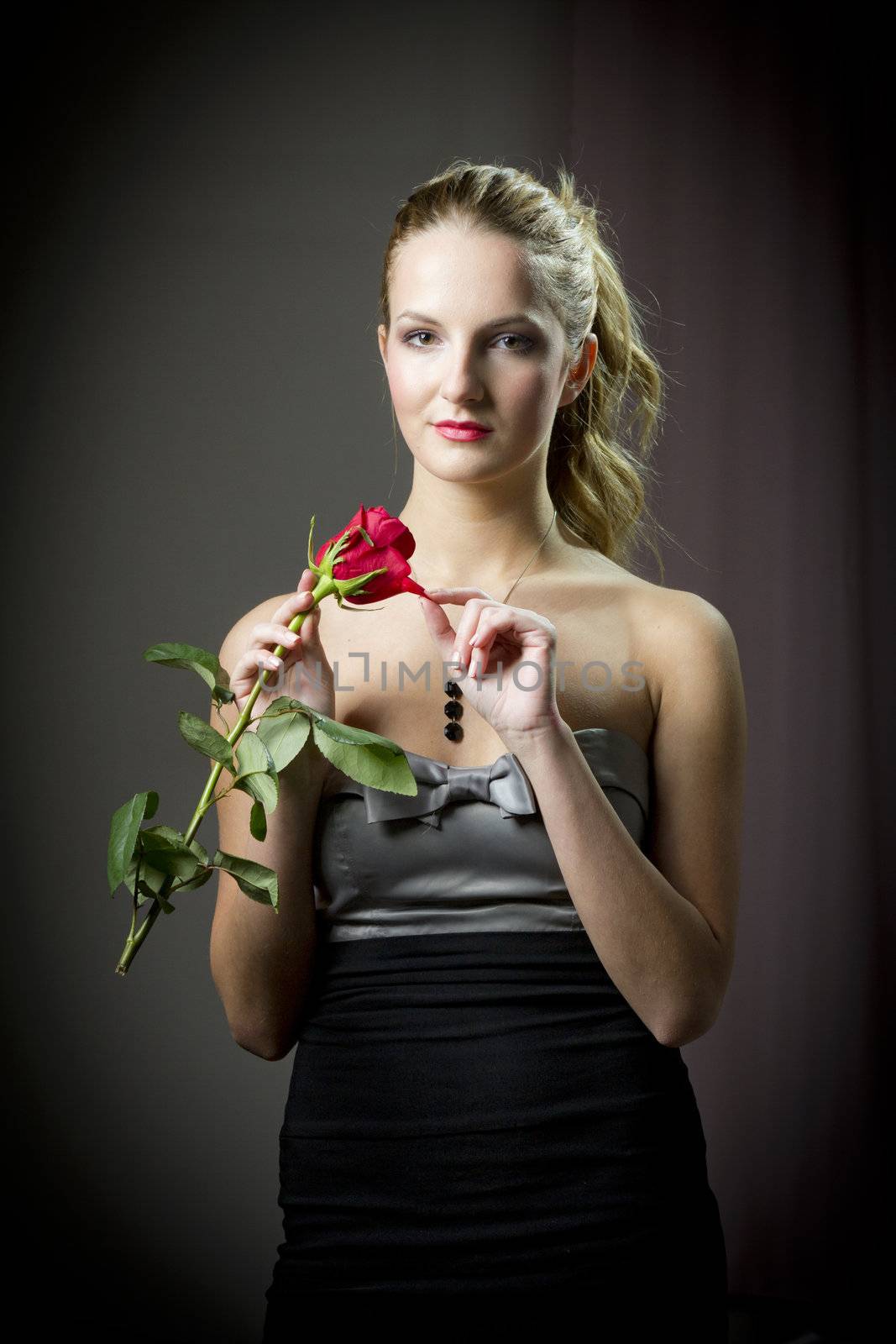 Attractive woman holding a rose on Valentine's day,