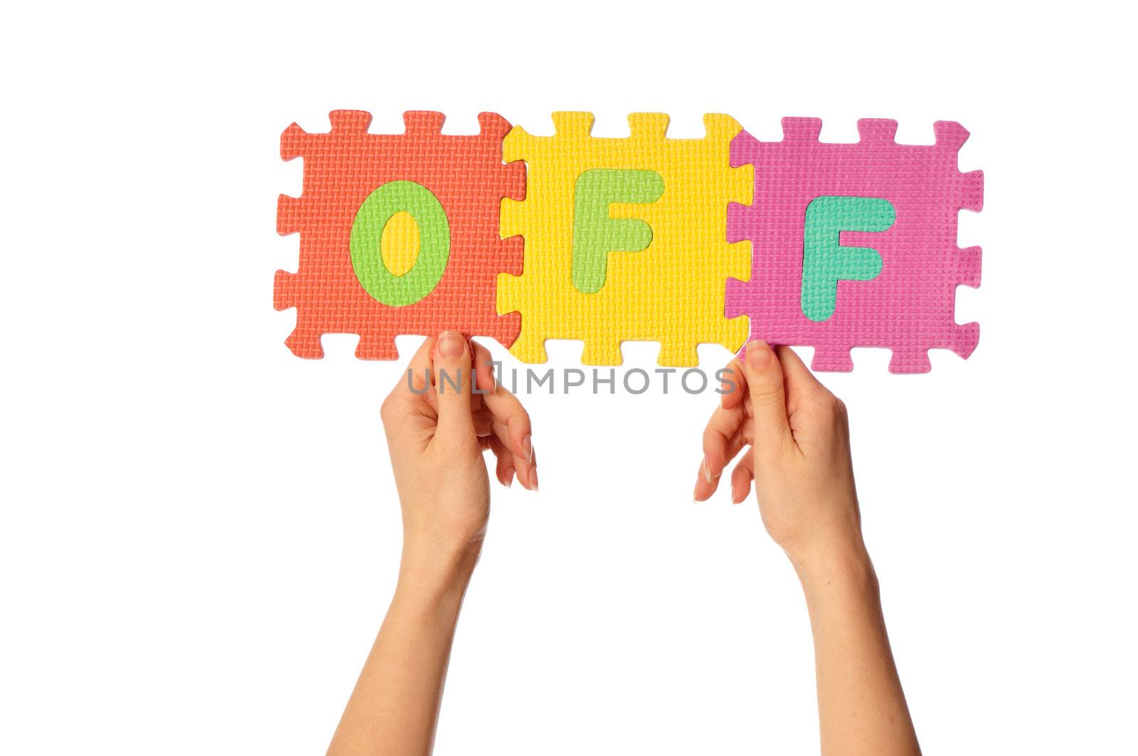 teacher holding in the hand the amusing colored educational puzzles with the word off