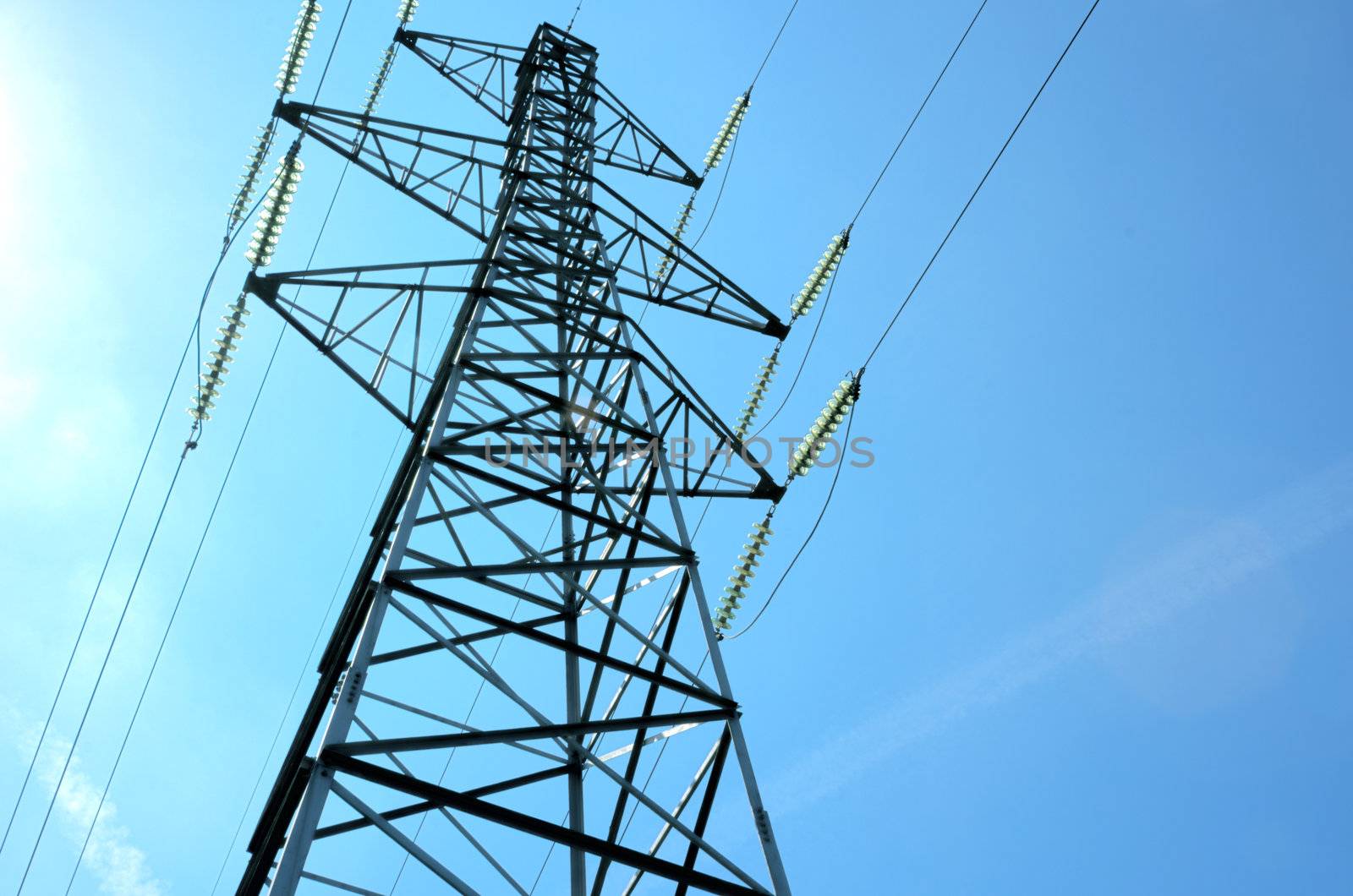 An electricity power tower against a blue sky