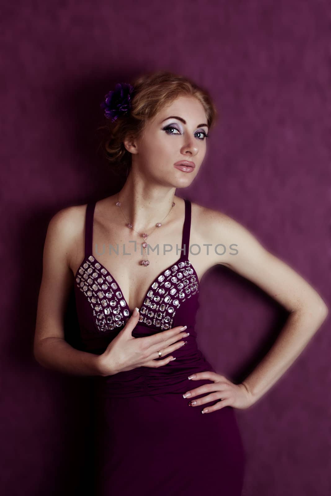 Retro-styled woman in violet dress and flower