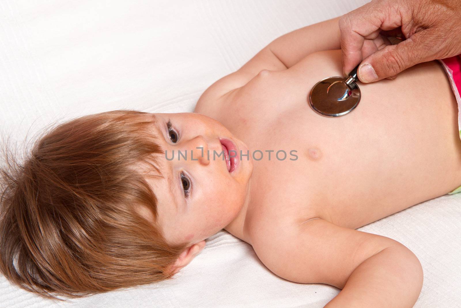 Children's doctor exams infant with stethoscope 