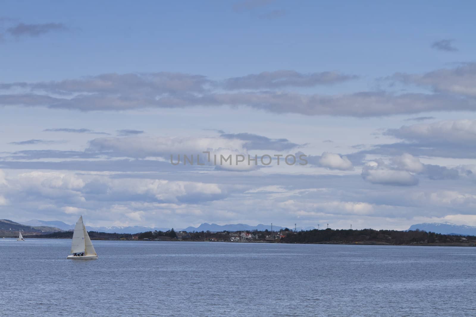 coastline with singel sailing boat in norway by gewoldi